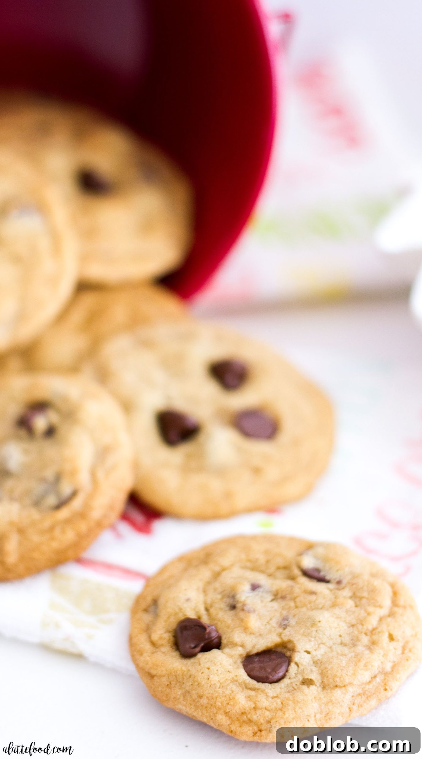Close-up of a stack of mini chocolate chip cookies, showcasing their chewy texture and melted chocolate chips.
