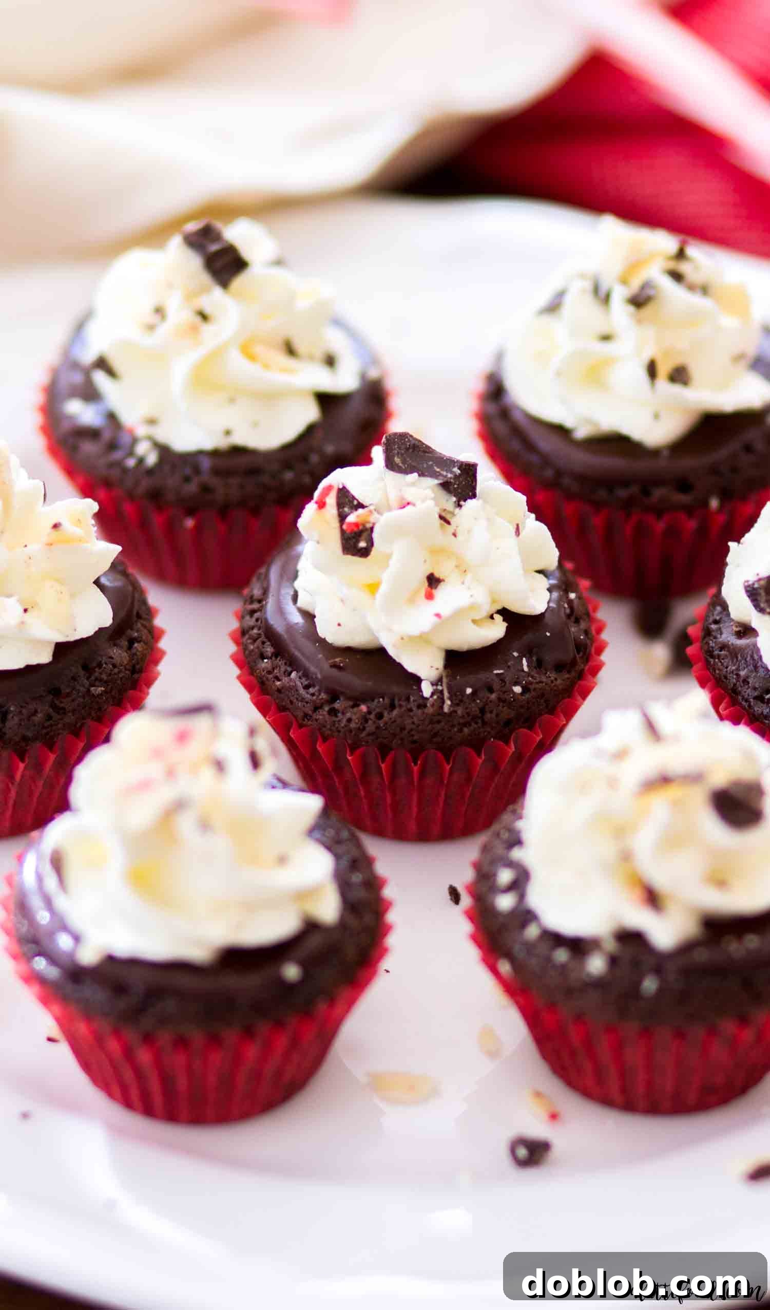Decadent mini flourless chocolate peppermint cupcakes: rich, fudgy, and a perfect gluten-free Christmas dessert with peppermint ganache and stabilized whipped cream frosting. #chocolate #dessert #glutenfree #cupcakes #peppermint The best flourless chocolate cupcakes with peppermint are super easy to make and are so festive for the holiday, perfect for a gluten-free Christmas dessert.