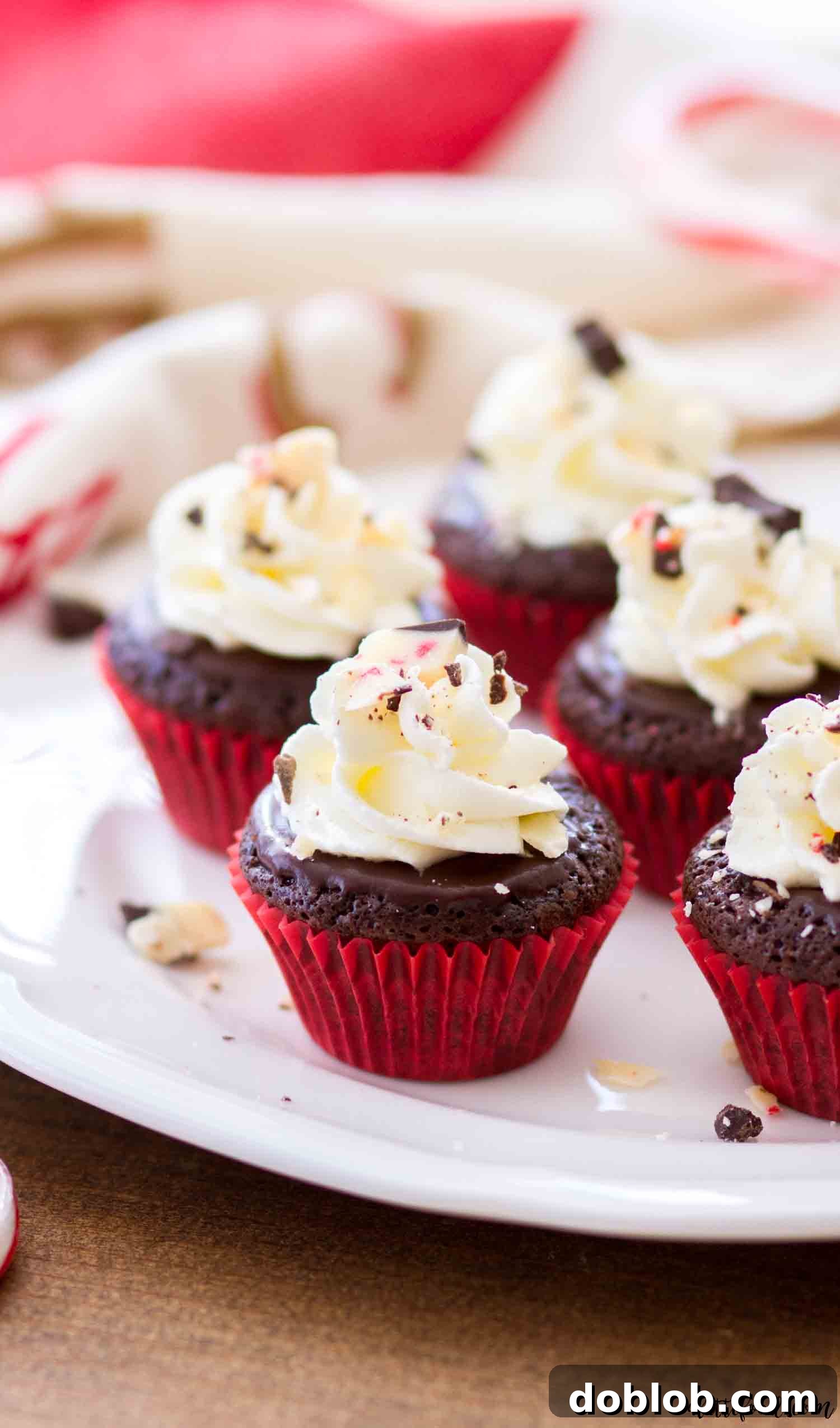 These mini flourless chocolate peppermint cupcakes are rich, fudgy, and a perfect gluten-free Christmas dessert with peppermint ganache and stabilized whipped cream frosting. #chocolate #dessert #glutenfree #cupcakes #peppermint Flourless chocolate cupcakes with peppermint are topped with a luscious peppermint ganache and a cloud of stabilized whipped cream frosting, creating a stunning holiday treat.