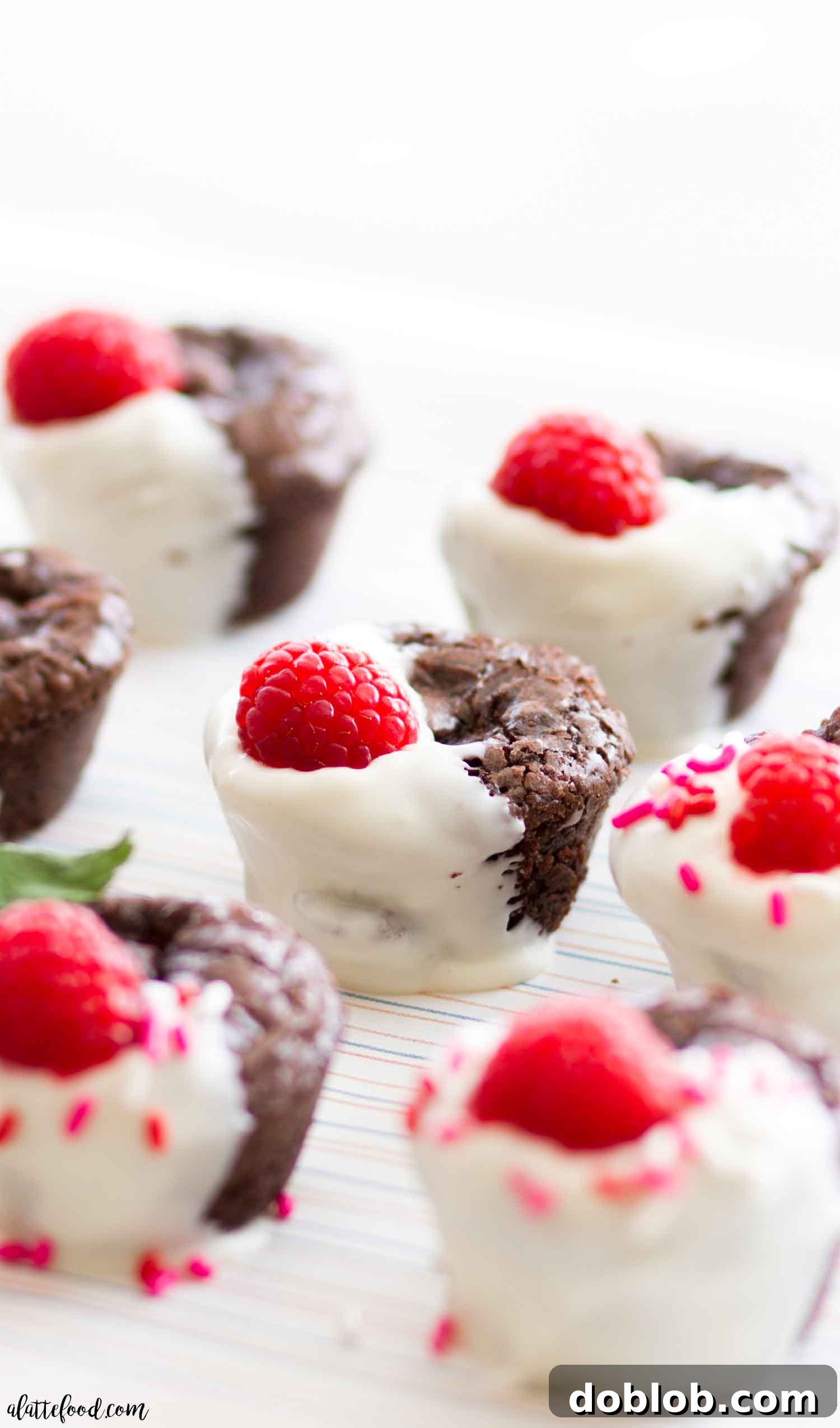 Decadent Chocolate Pound Cake 4 Delicious fudgy brownie bites adorned with fresh raspberries and drizzled with white chocolate, offering a perfect sweet and tart balance.