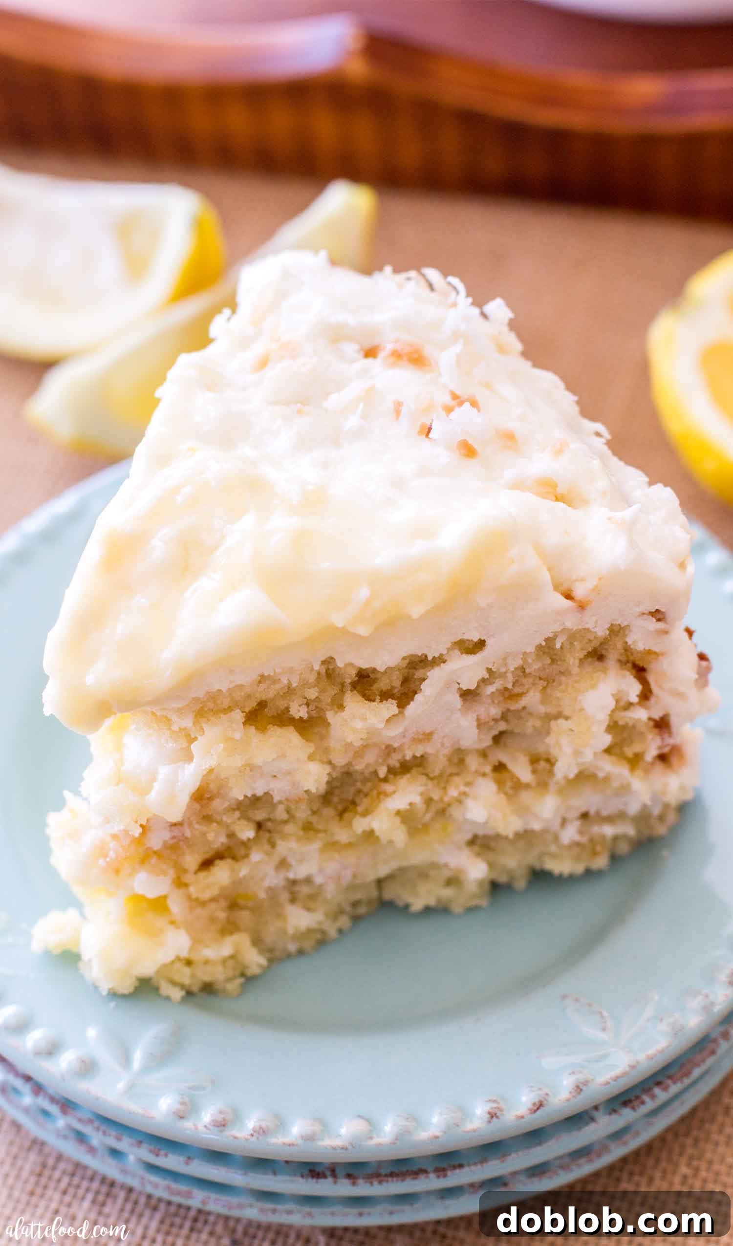 slice of coconut lemon cake on teal plates