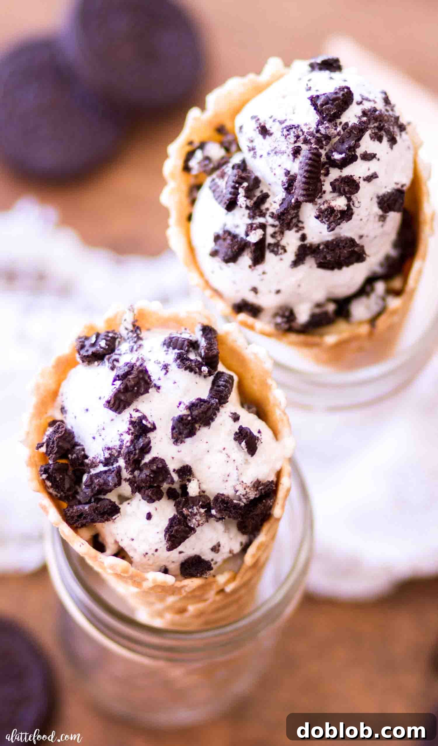 Four Deliciously Easy Ice Cream Sundae Recipes 3 A close-up shot of easy cookies and cream ice cream served in a crispy waffle cone, highlighting the crushed Oreo pieces mixed with creamy vanilla ice cream