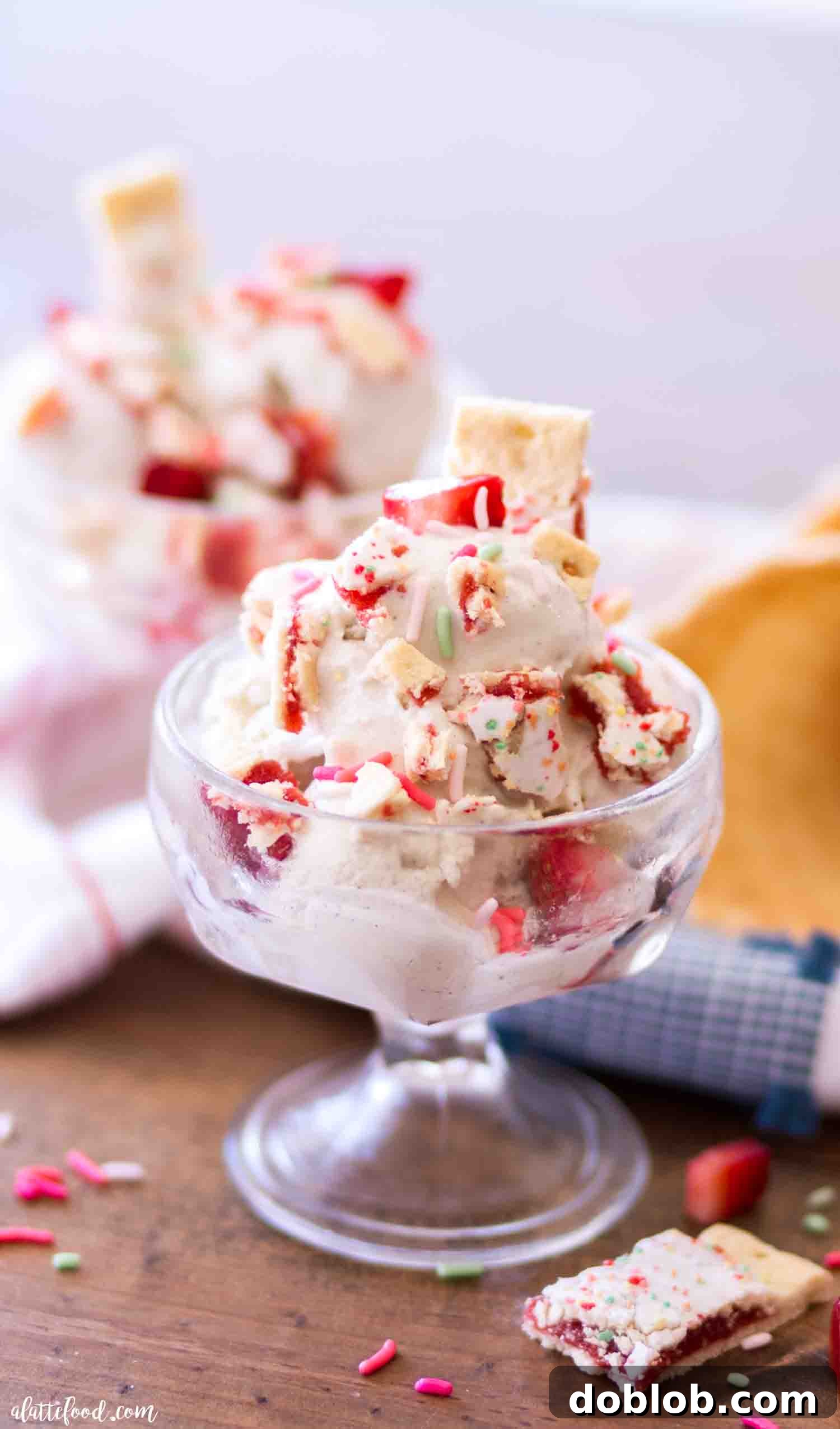 Four Deliciously Easy Ice Cream Sundae Recipes 9 A refreshing Strawberry Pop Tart Vanilla Ice Cream Sundae, garnished with colorful sprinkles and vibrant fresh strawberries, perfectly presented for a fun summer gathering