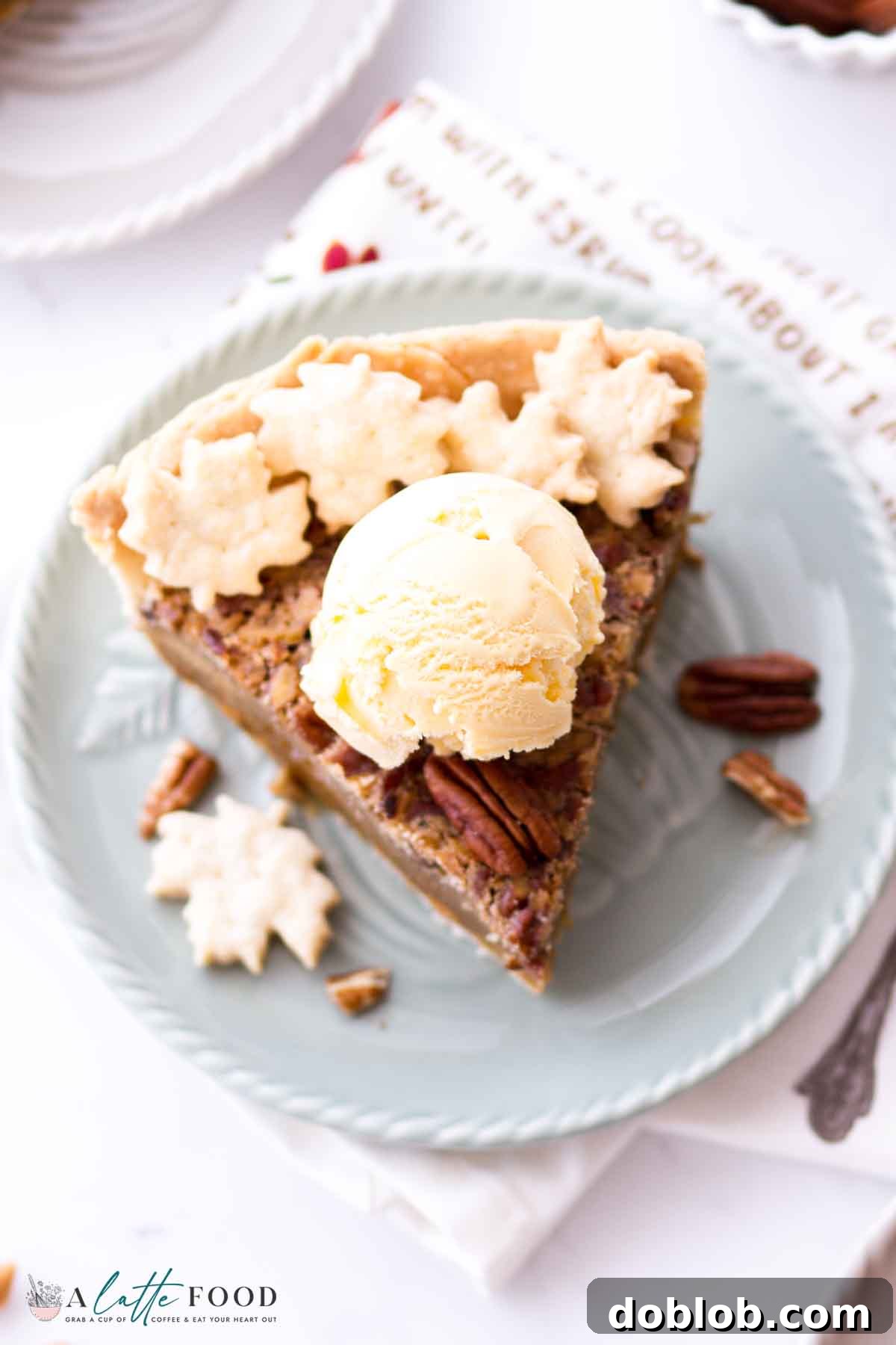 A luscious slice of Butterscotch Pecan Pie, crowned with melting vanilla ice cream, promising a delightful blend of warm and cool textures.