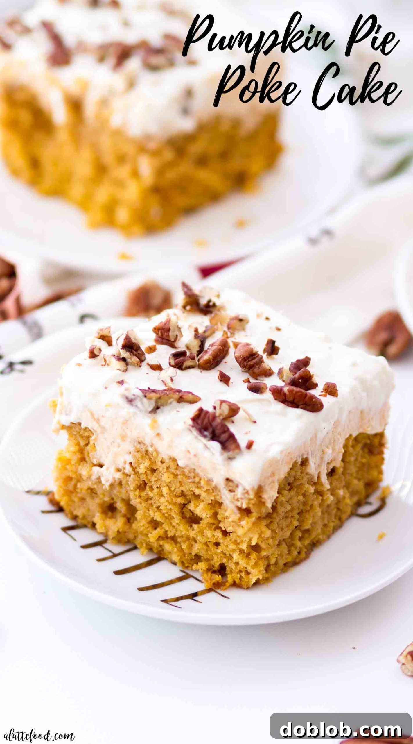The best pumpkin poke cake slice showing layers of moist cake, pumpkin cream filling, and whipped cream cheese frosting, garnished with toasted pecans on a white plate.