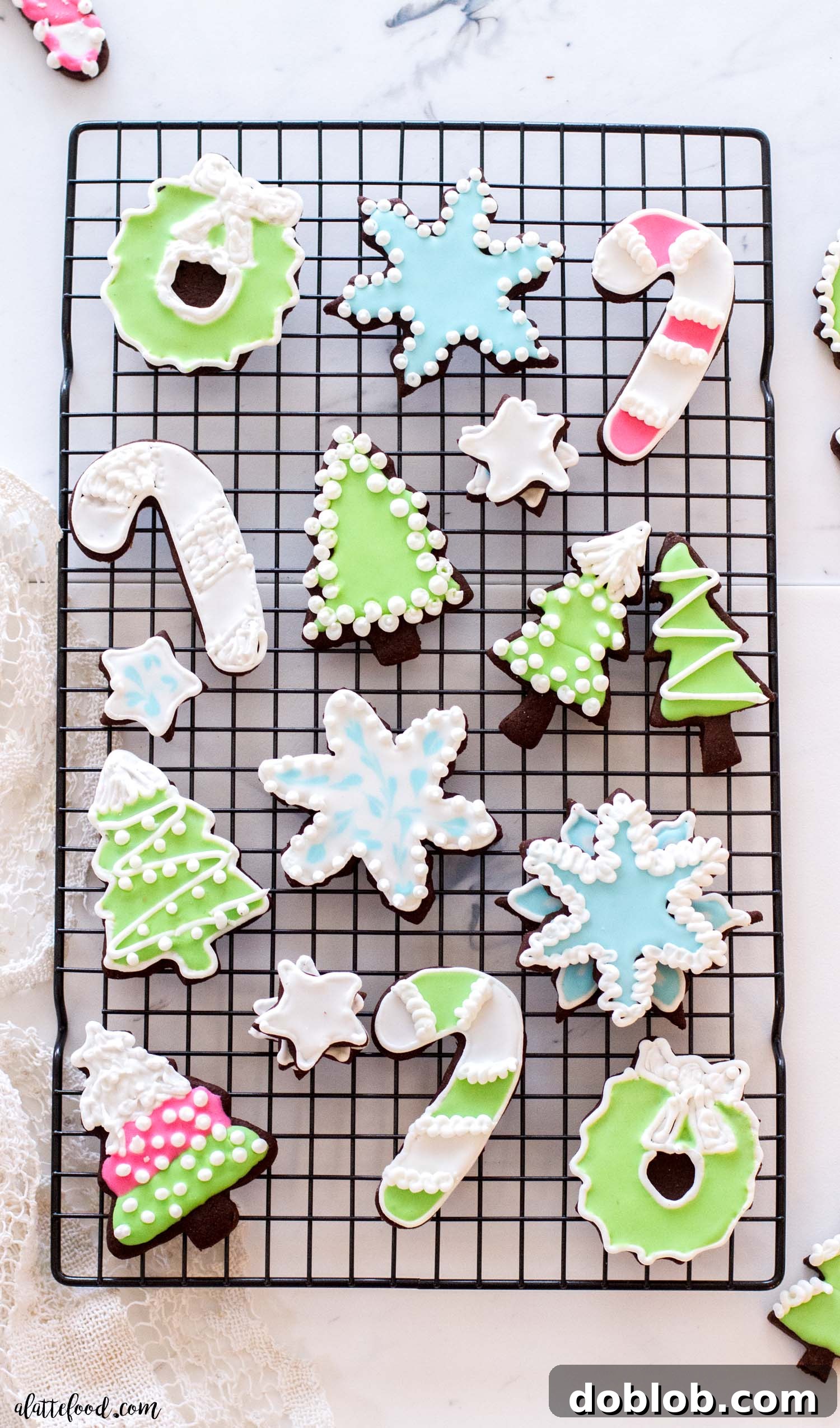 Perfect Royal Icing Made Simple 5 Rich and fudgy chocolate cutout sugar cookies resting on a wire cooling rack, awaiting their artistic royal icing or buttercream decorations.
