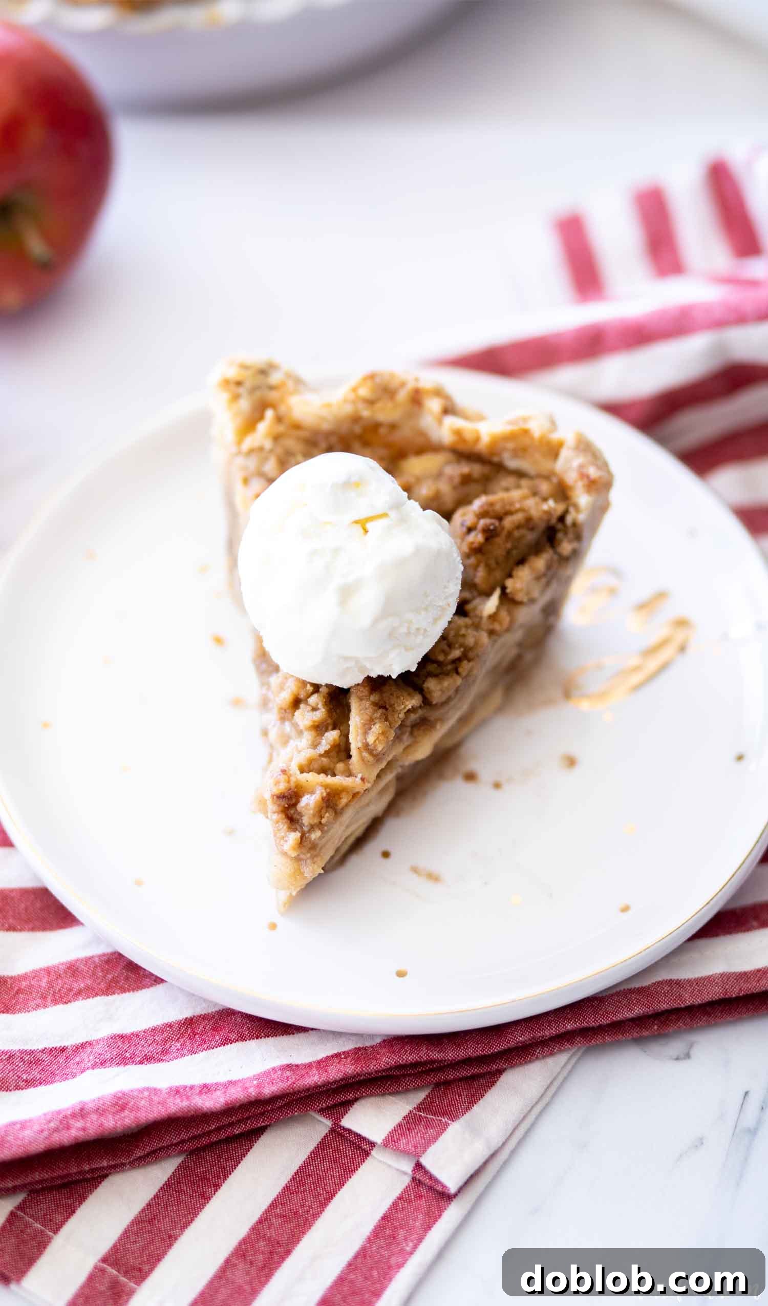 apple crumb pie slice a la mode on white and gold plate