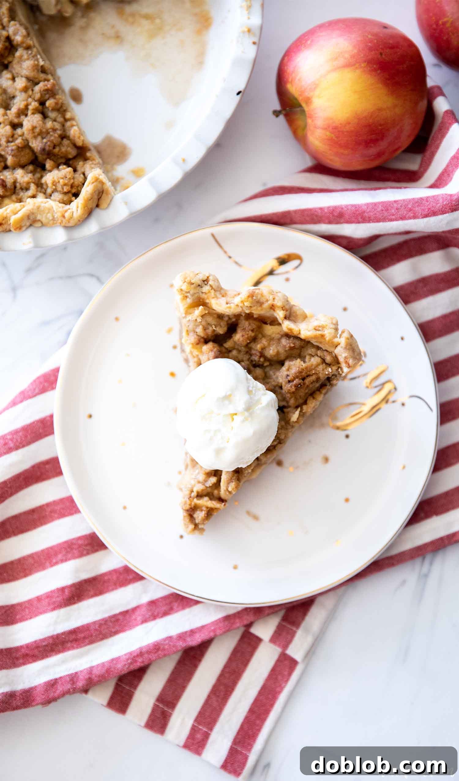 pie slice with ice cream on red striped dish towel
