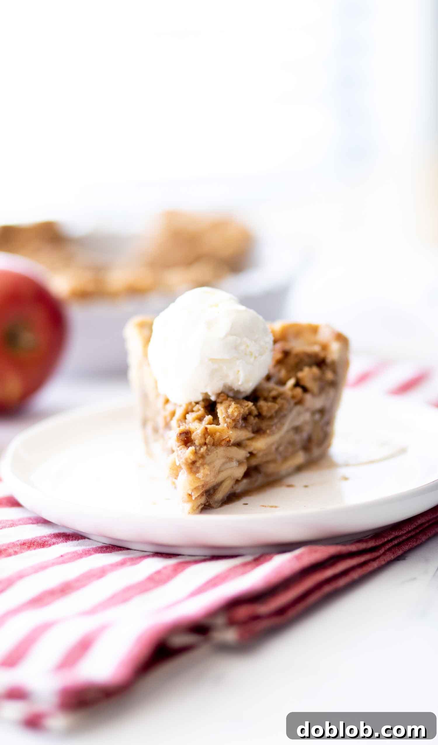 slice of apple pie on white plate 