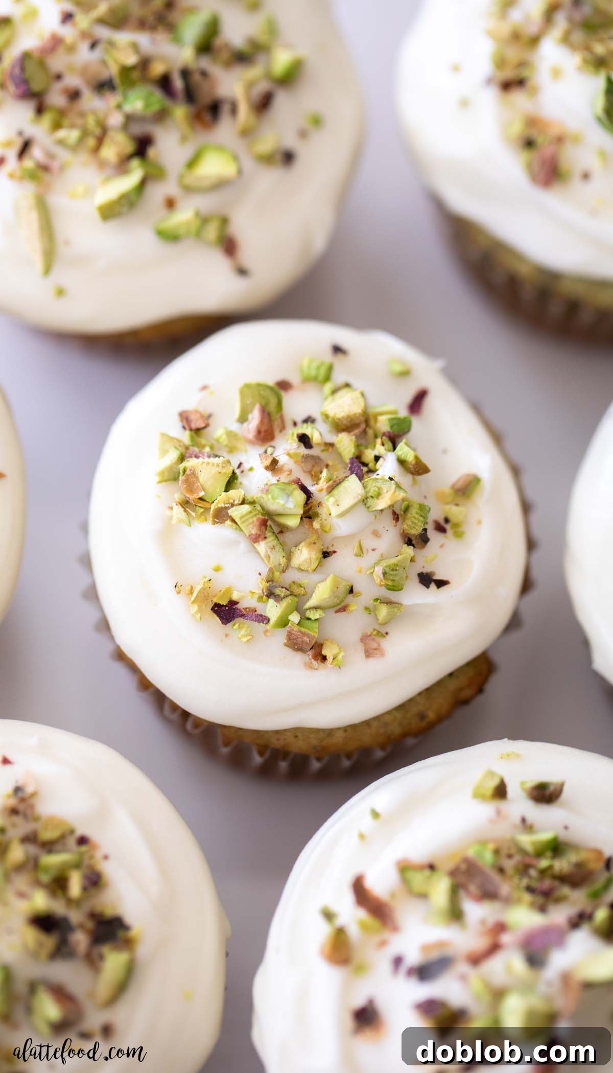 Experience the best homemade Honey Pistachio Cupcakes, featuring a light, fluffy texture, buttery-nutty flavor, and rich, silky cream cheese frosting. Made from scratch with real pistachios, almond, and honey. Cream cheese frosted honey pistachio cupcakes with pistachios