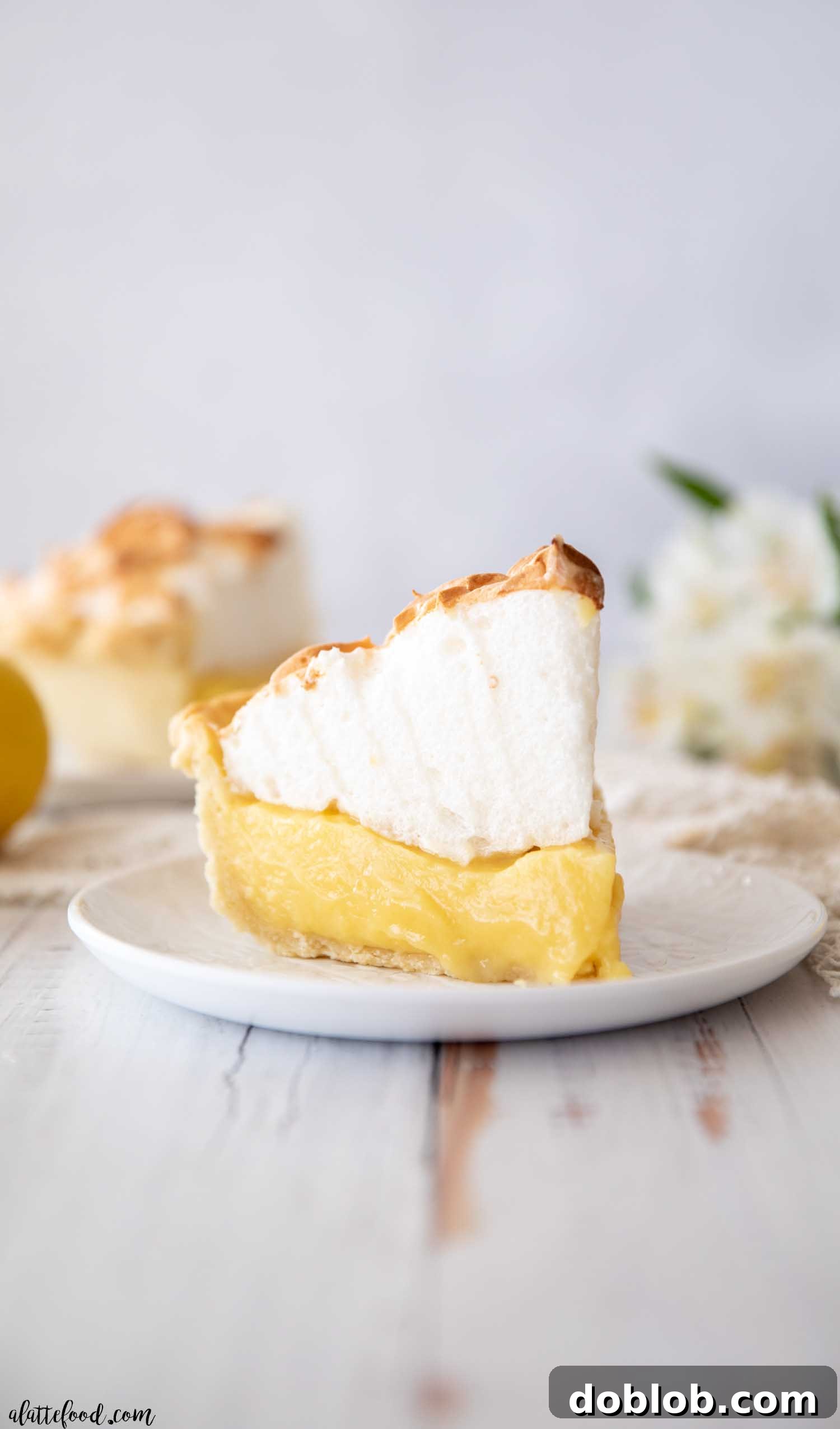 Sweet Honey Pistachio Delights with Cream Cheese 3 Sliced lemon meringue pie on a white plate