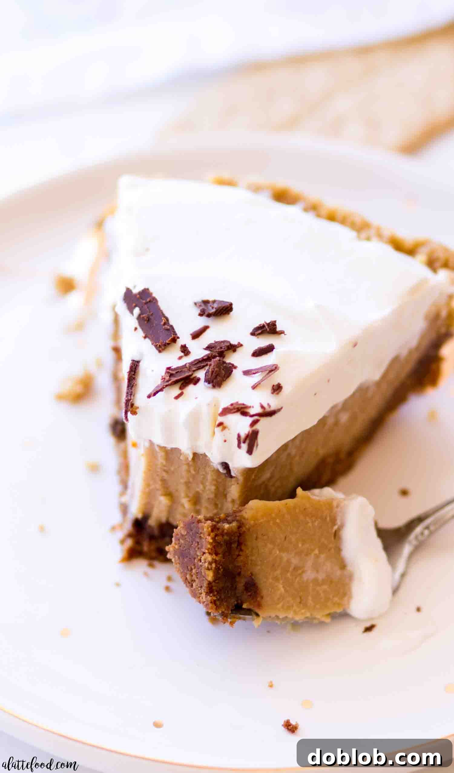 A slice of creamy Peanut Butter Pie with peanut butter custard on a white plate