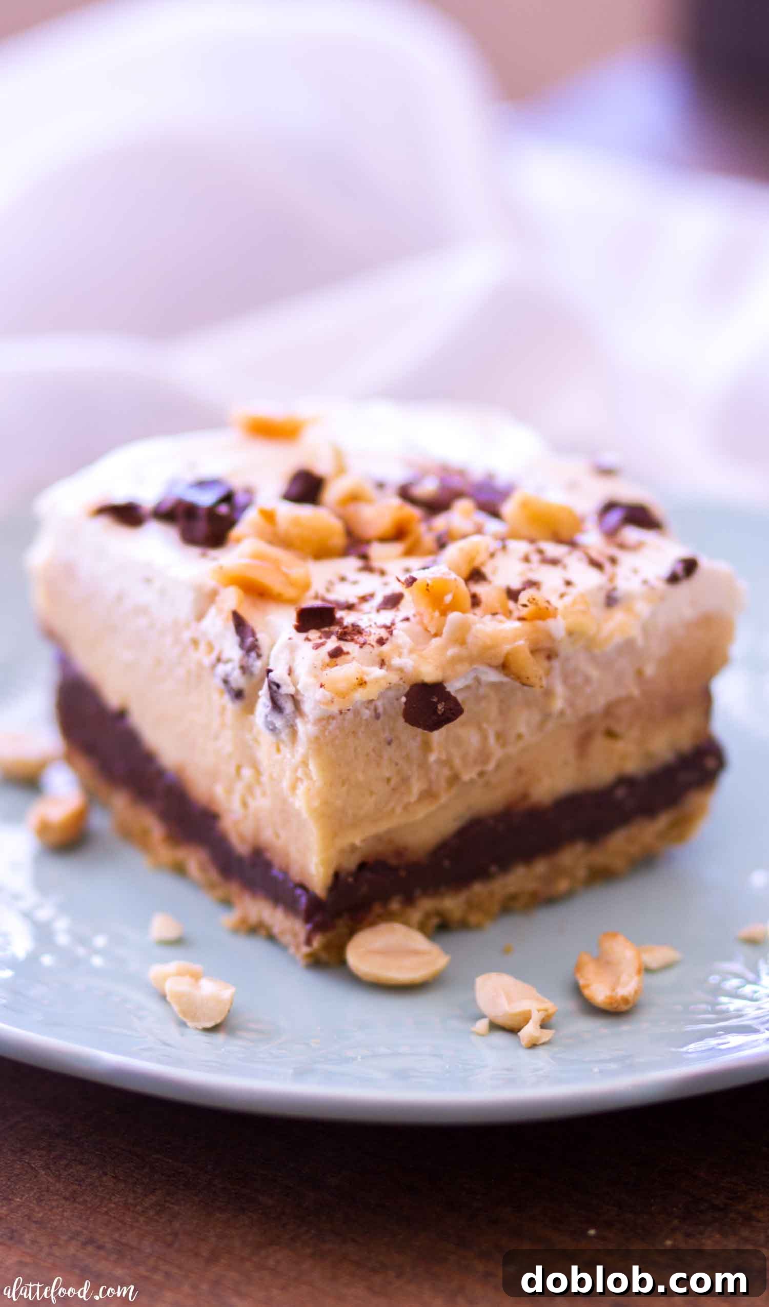 These no-bake chocolate peanut butter pie bars feature layers of graham cracker crumbs, homemade chocolate ganache, peanut butter cream filling, and homemade whipped cream on top. A dream for chocolate and peanut butter lovers!