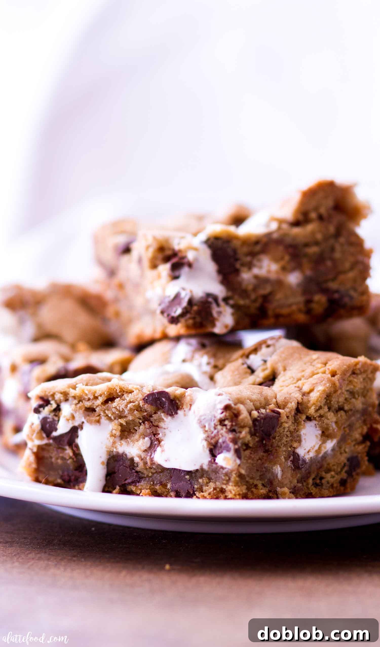 A stack of peanut butter chocolate chip cookie bars with marshmallow filling