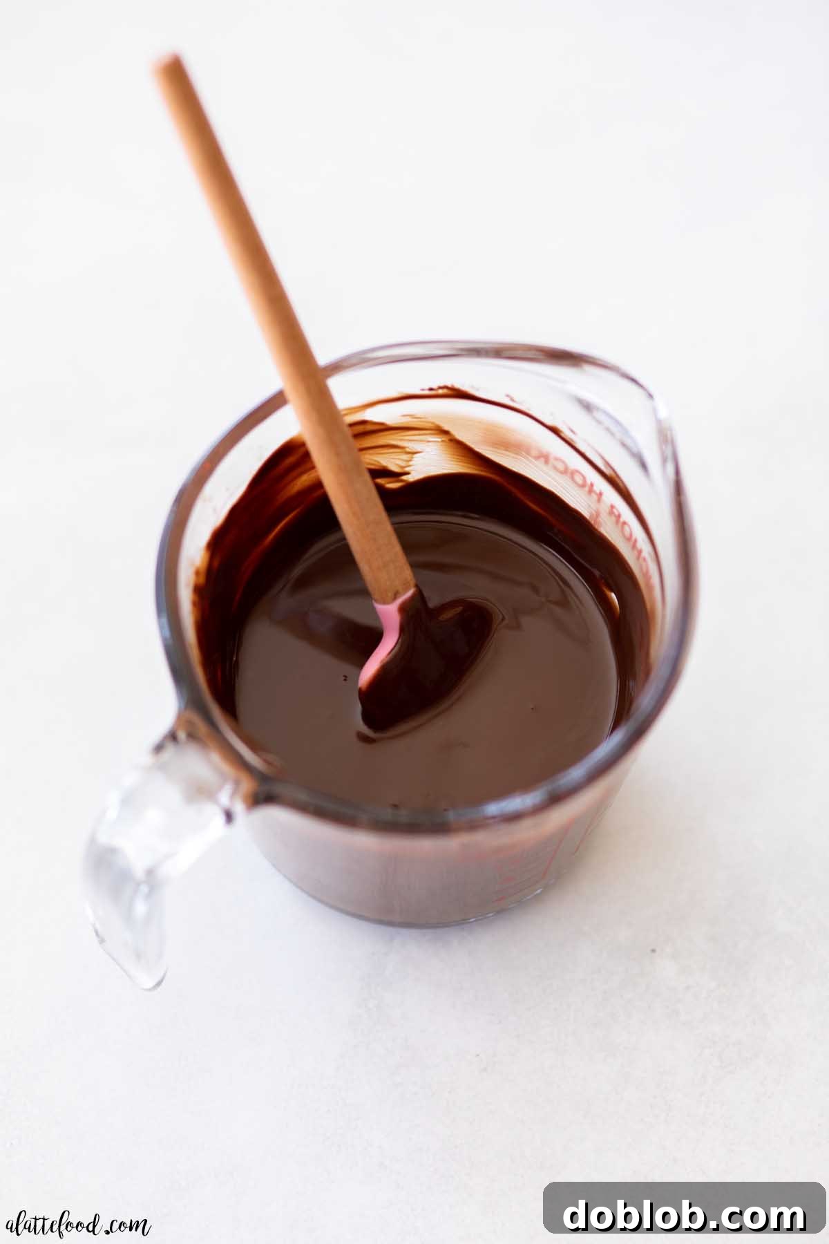Homemade magic shell in a glass measuring cup, ready for dipping