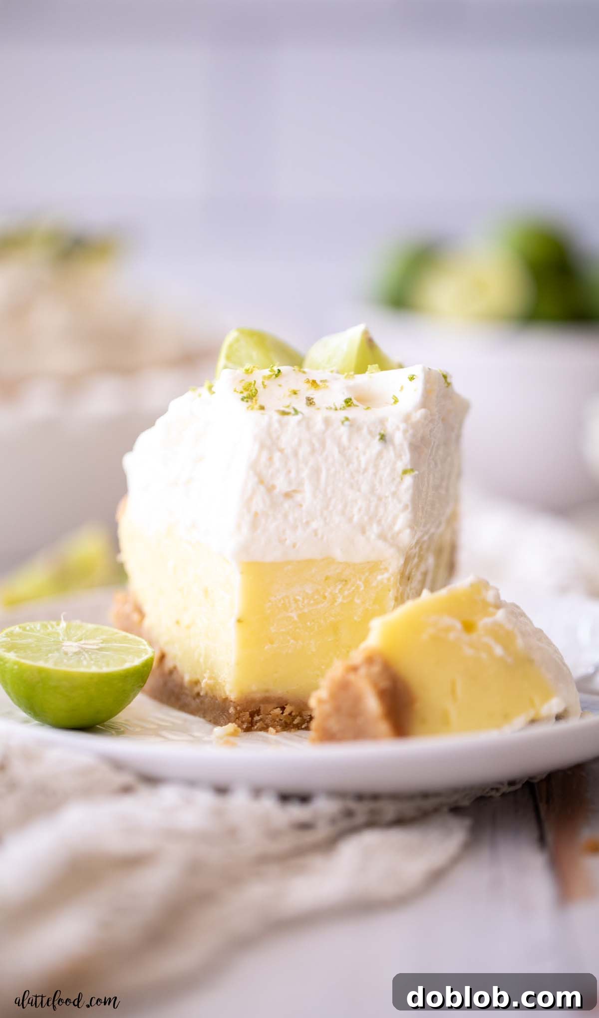 key lime pie slice with a graham cracker crust, custard filling, and whipped cream