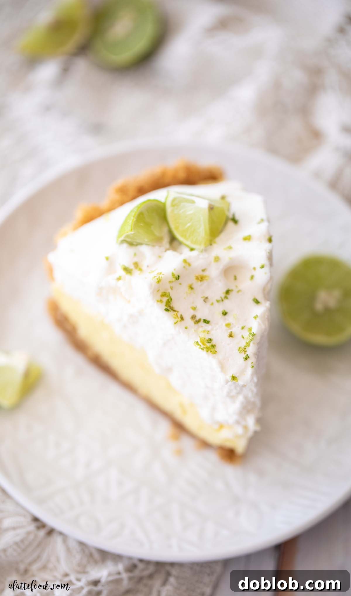 key lime cream pie slice with fresh key limes