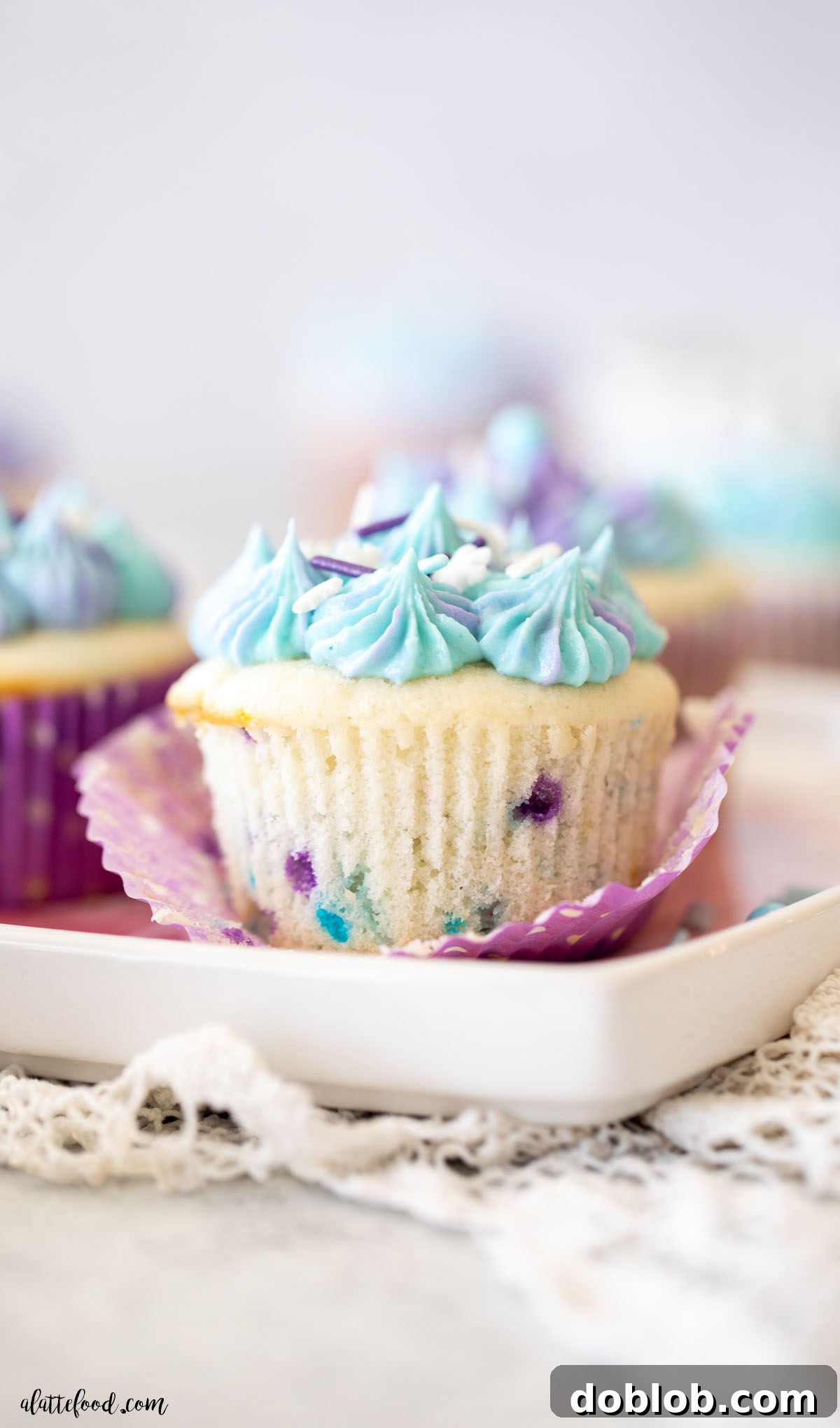 funfetti cupcake made from scratch with purple sprinkles and blue and purple tie dye frosting