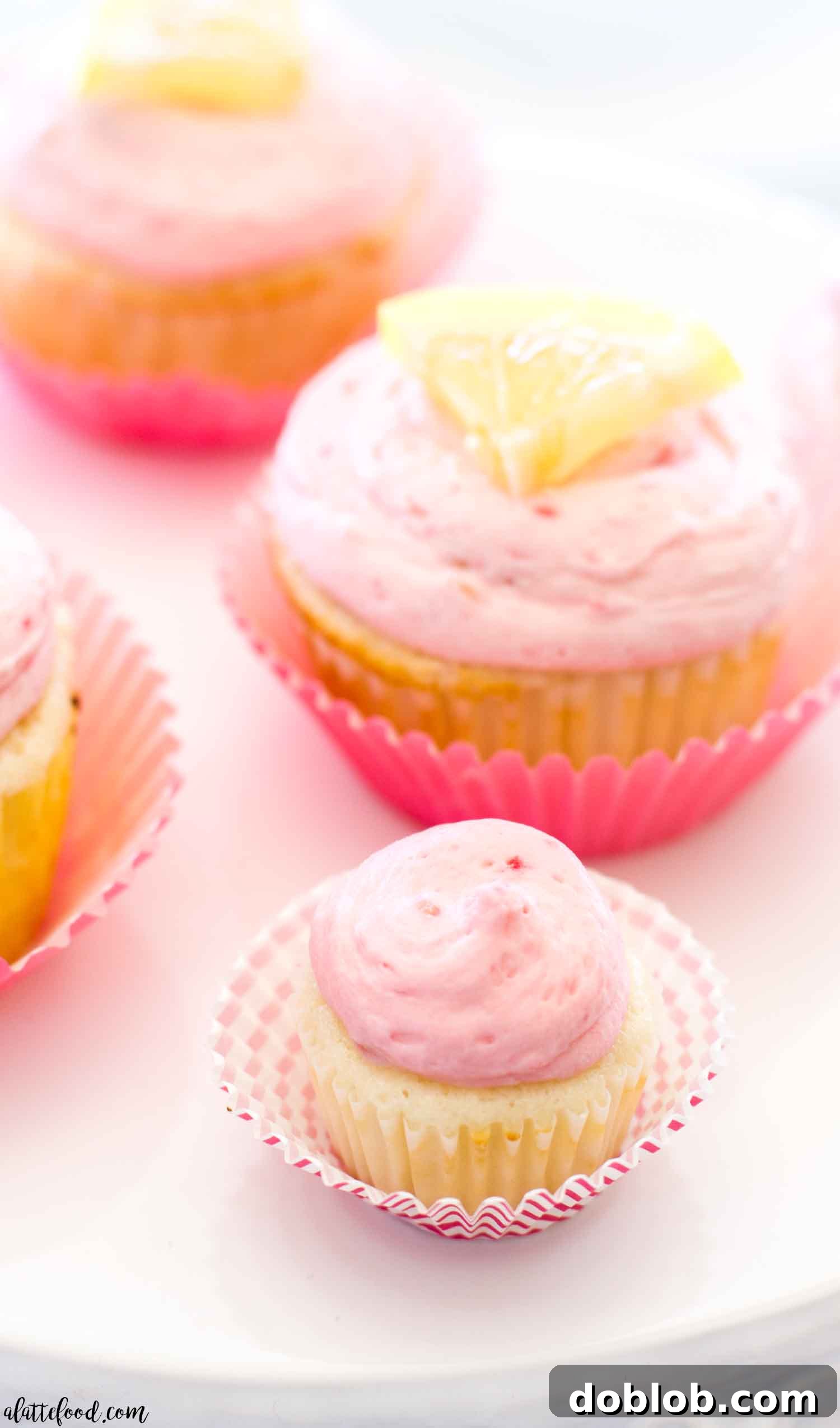 Lemon Cupcakes with Lemon Curd and Raspberry Buttercream: These light homemade lemon cupcakes are filled with tangy lemon curd and topped with rich homemade raspberry buttercream (raspberry frosting made with fresh raspberries!). These easy lemon cupcakes are sure to be a summer dessert favorite!