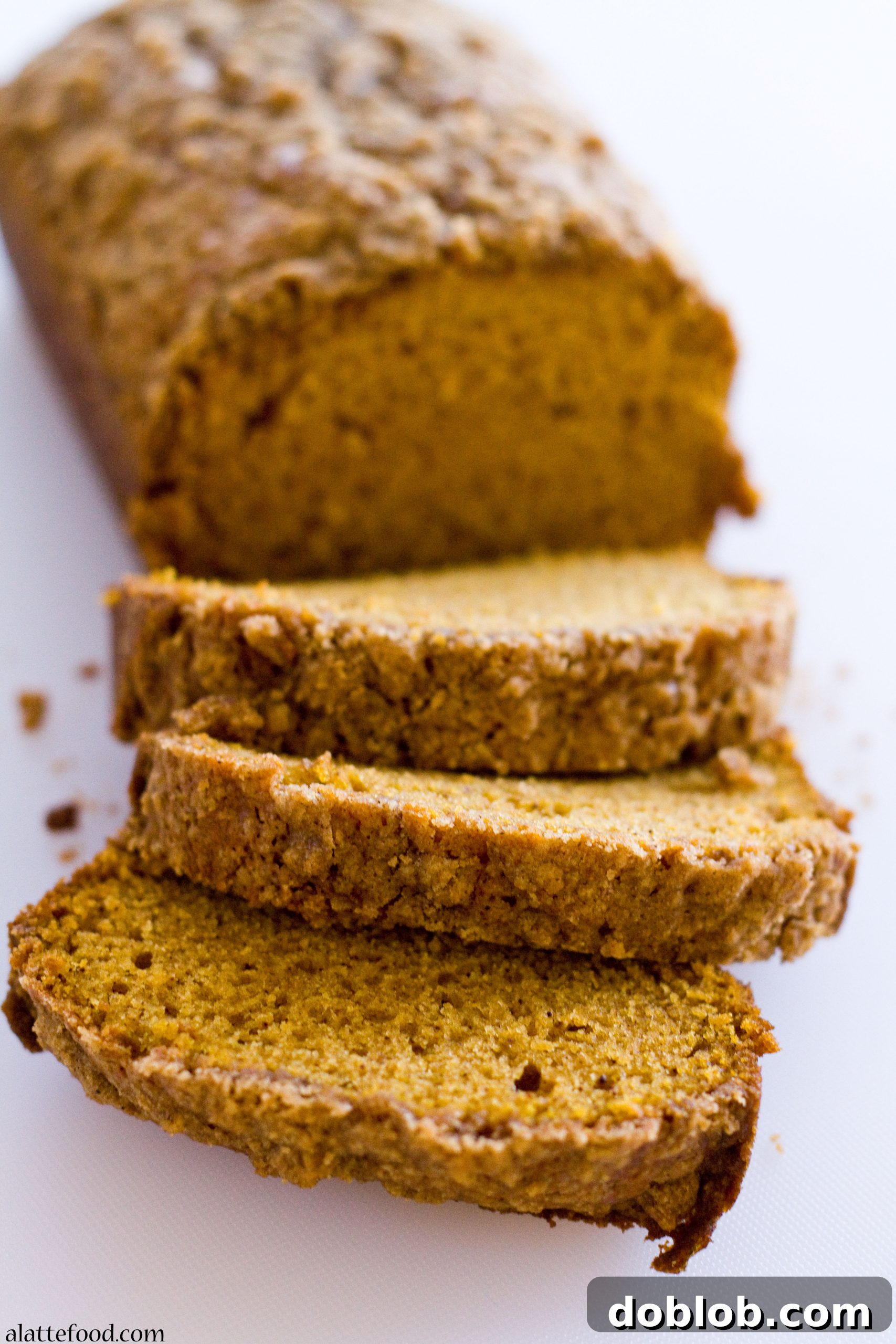 A wider shot of the Classic Pumpkin Streusel Bread with coffee, ready for a cozy moment.