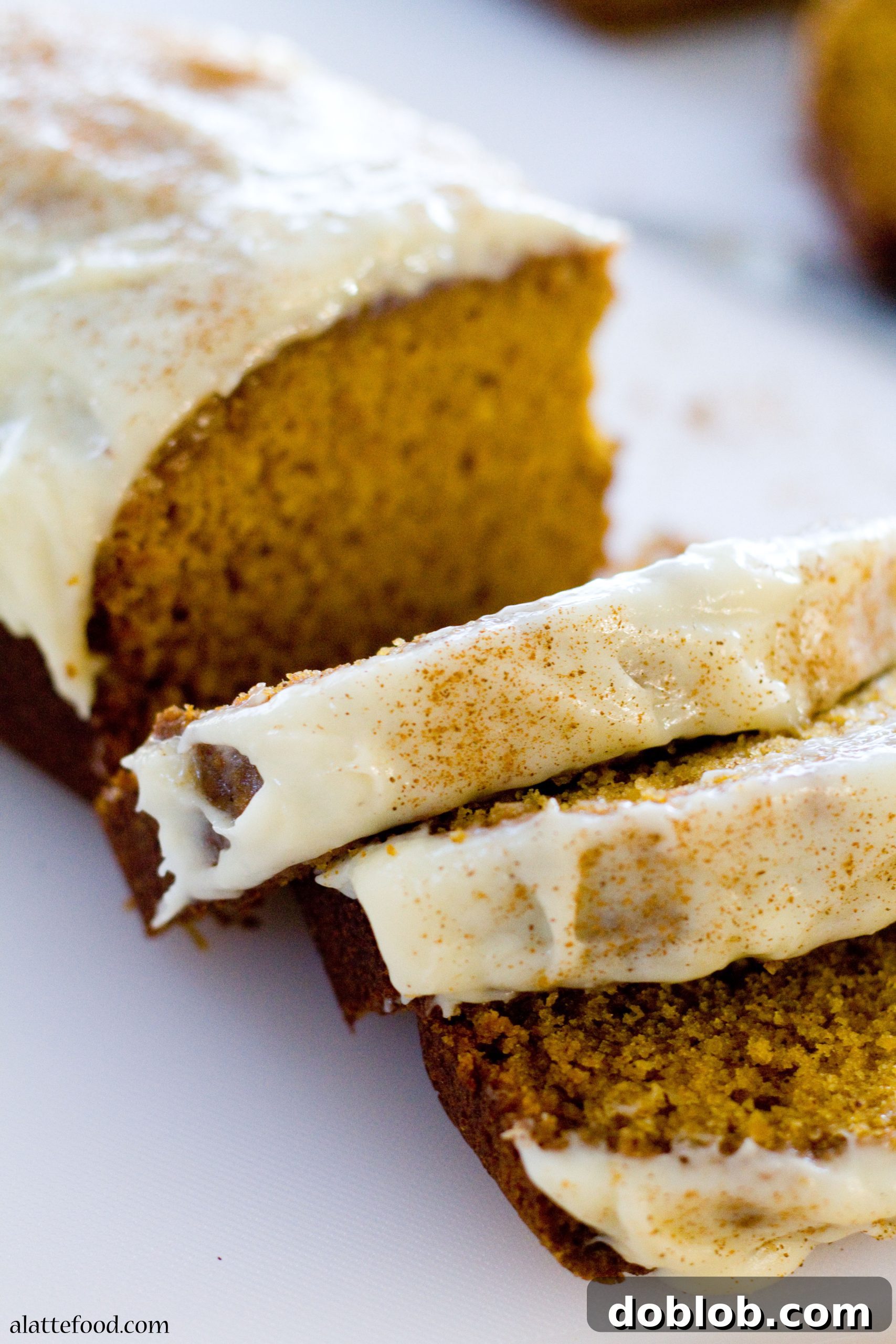 Classic Pumpkin Streusel Bread drizzled with a rich cream cheese glaze.