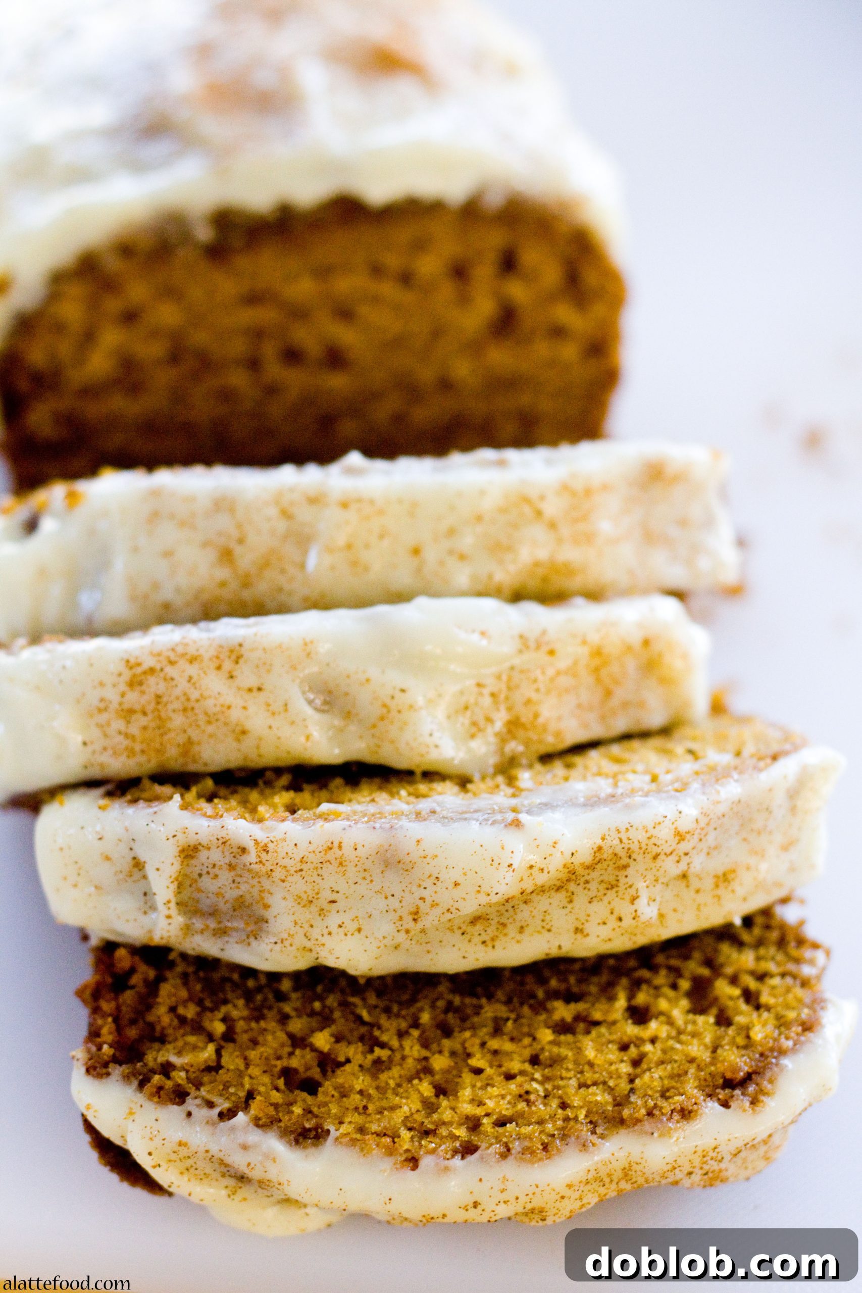 A beautifully presented slice of Classic Pumpkin Streusel Bread on a plate.