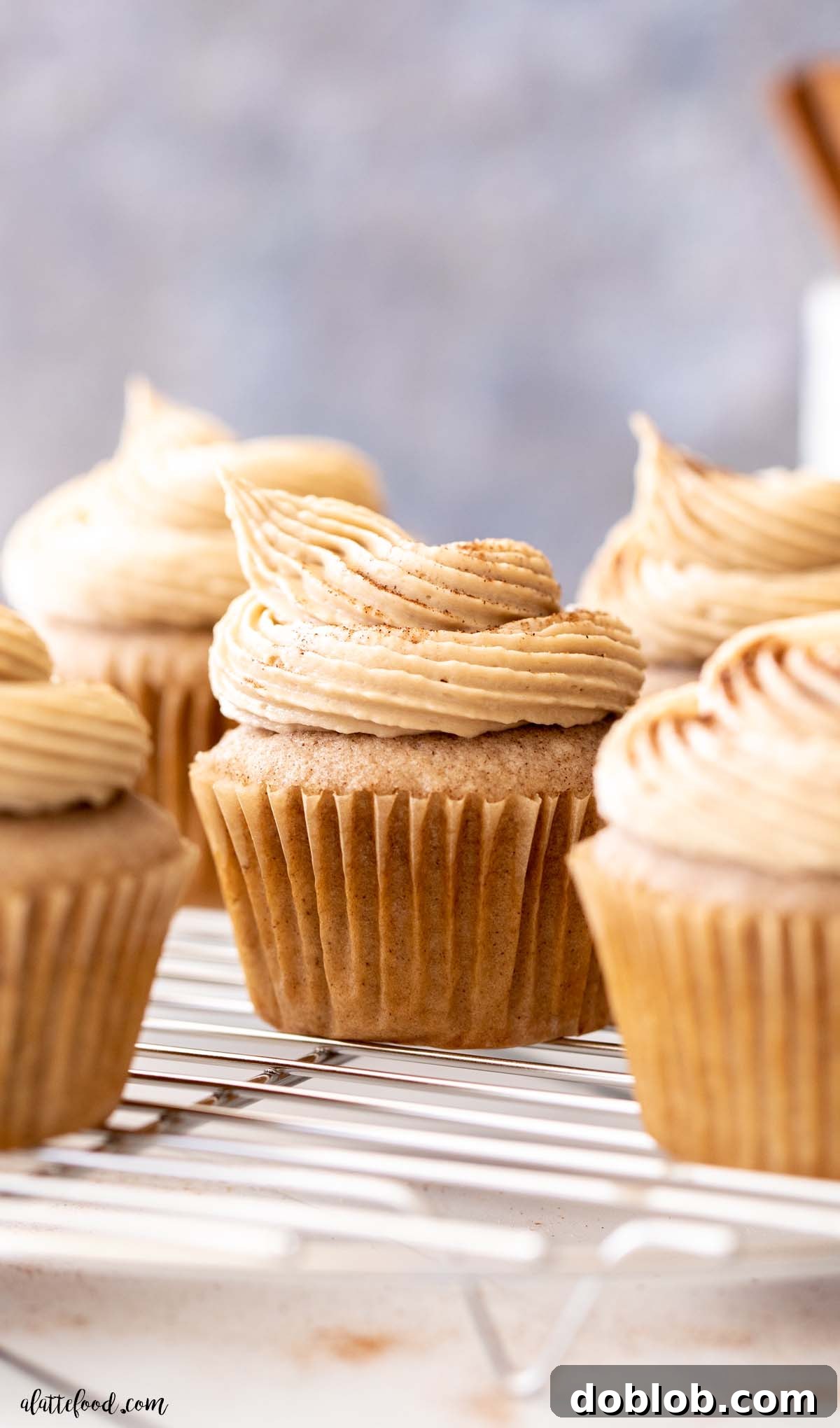 brown sugar buttercream frosted cinnamon cupcakes on metal cooling rack