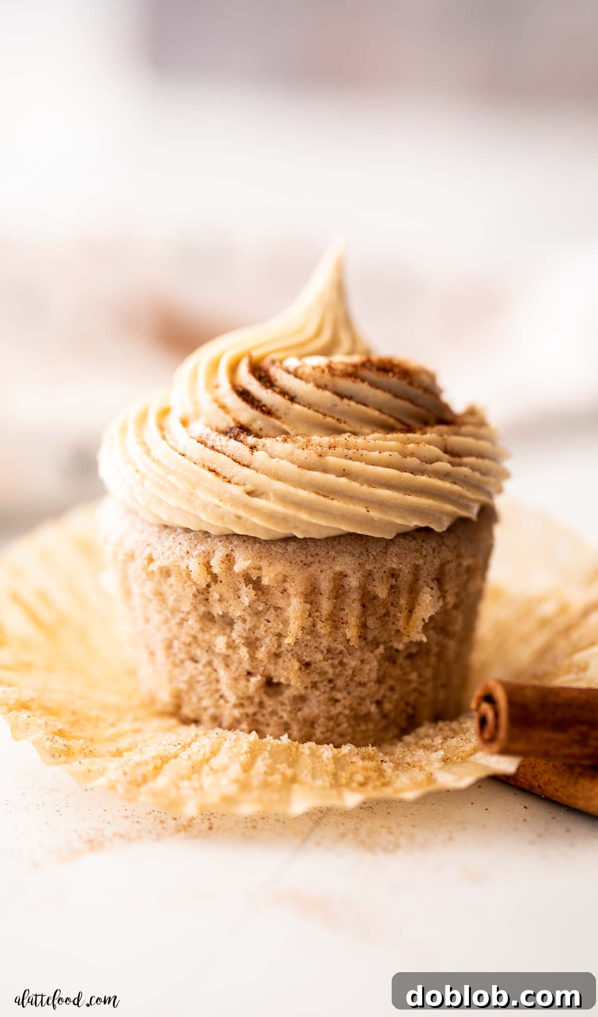 fluffy snickerdoodle cupcakes with brown sugar buttercream frosting with cinnamon sticks