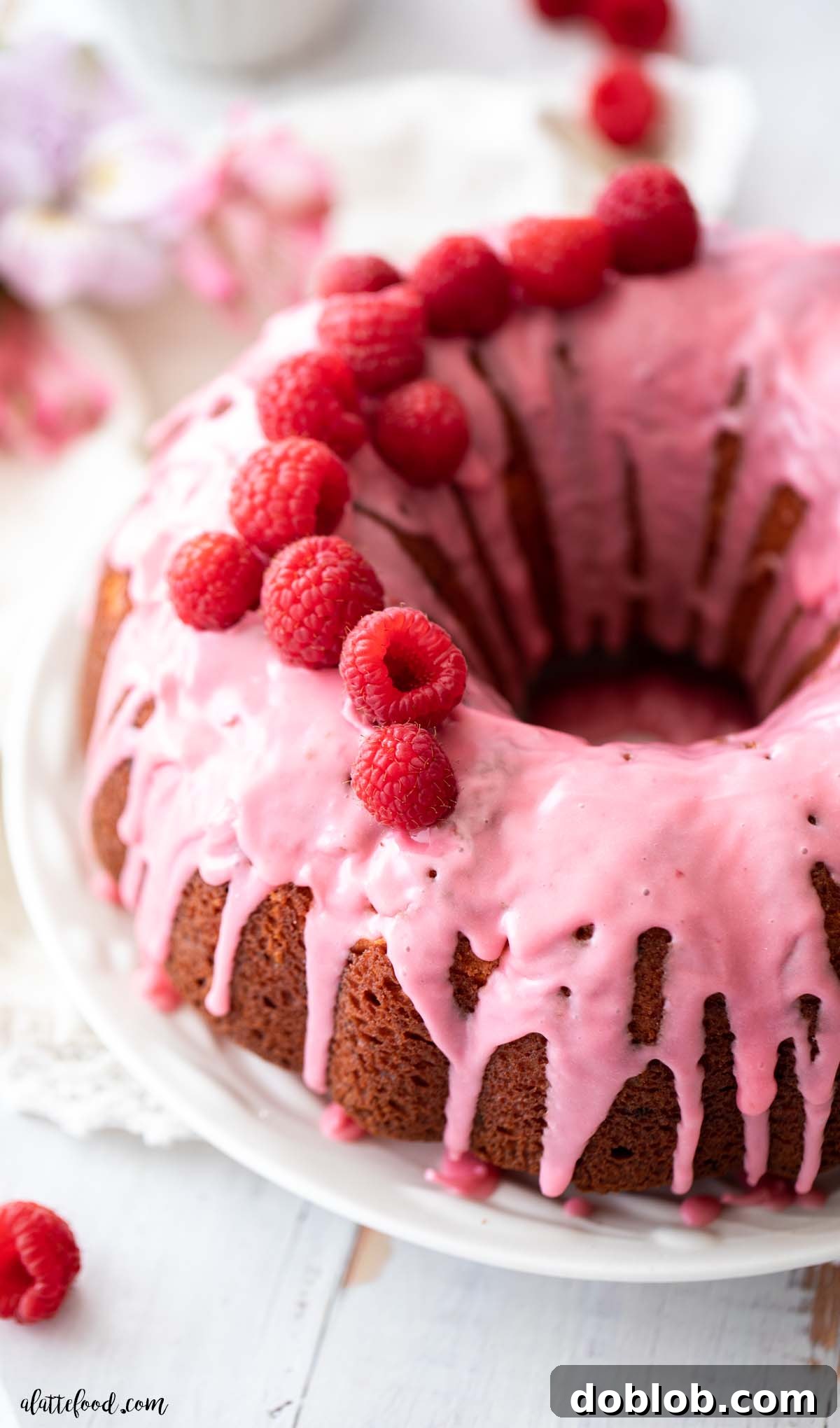 Sweet Nothings: Over 40 Valentine's Day Dessert Ideas 2 raspberry Bundt Cake with fresh raspberries on top on white plate