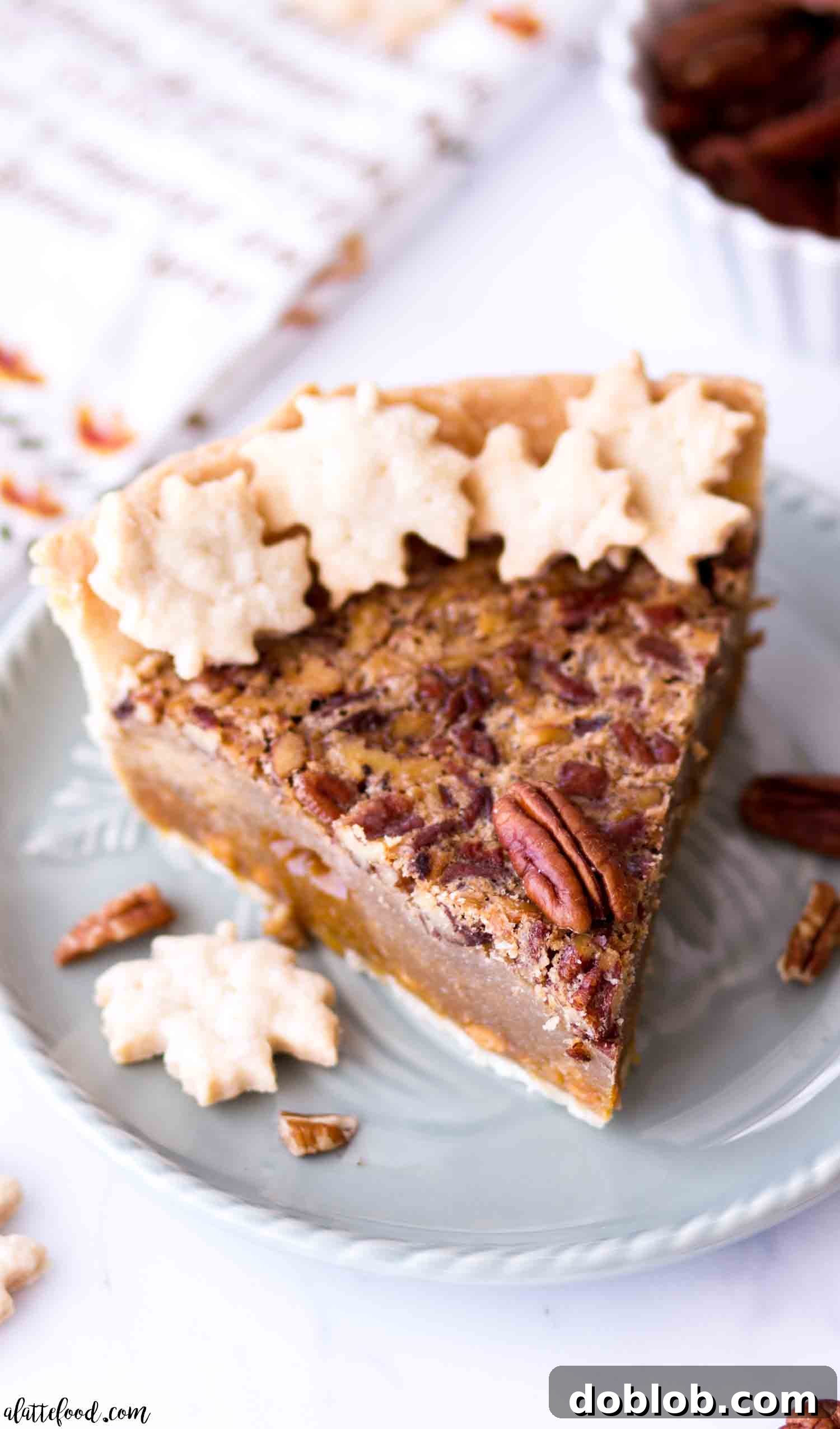 A slice of the best butterscotch pecan pie without corn syrup on a blue plate