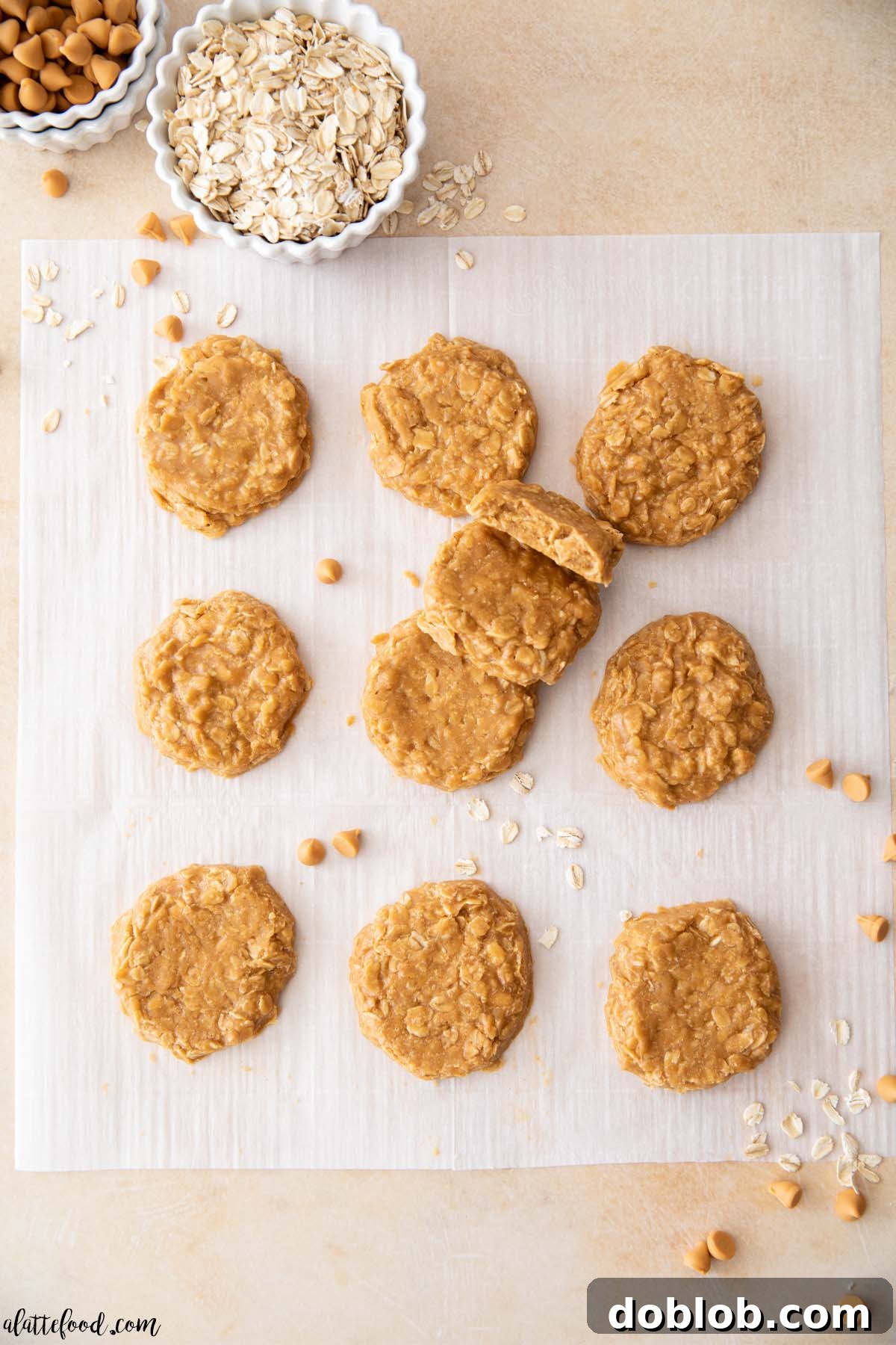 butterscotch no bake cookies on white parchment paper with oats and butterscotch chips