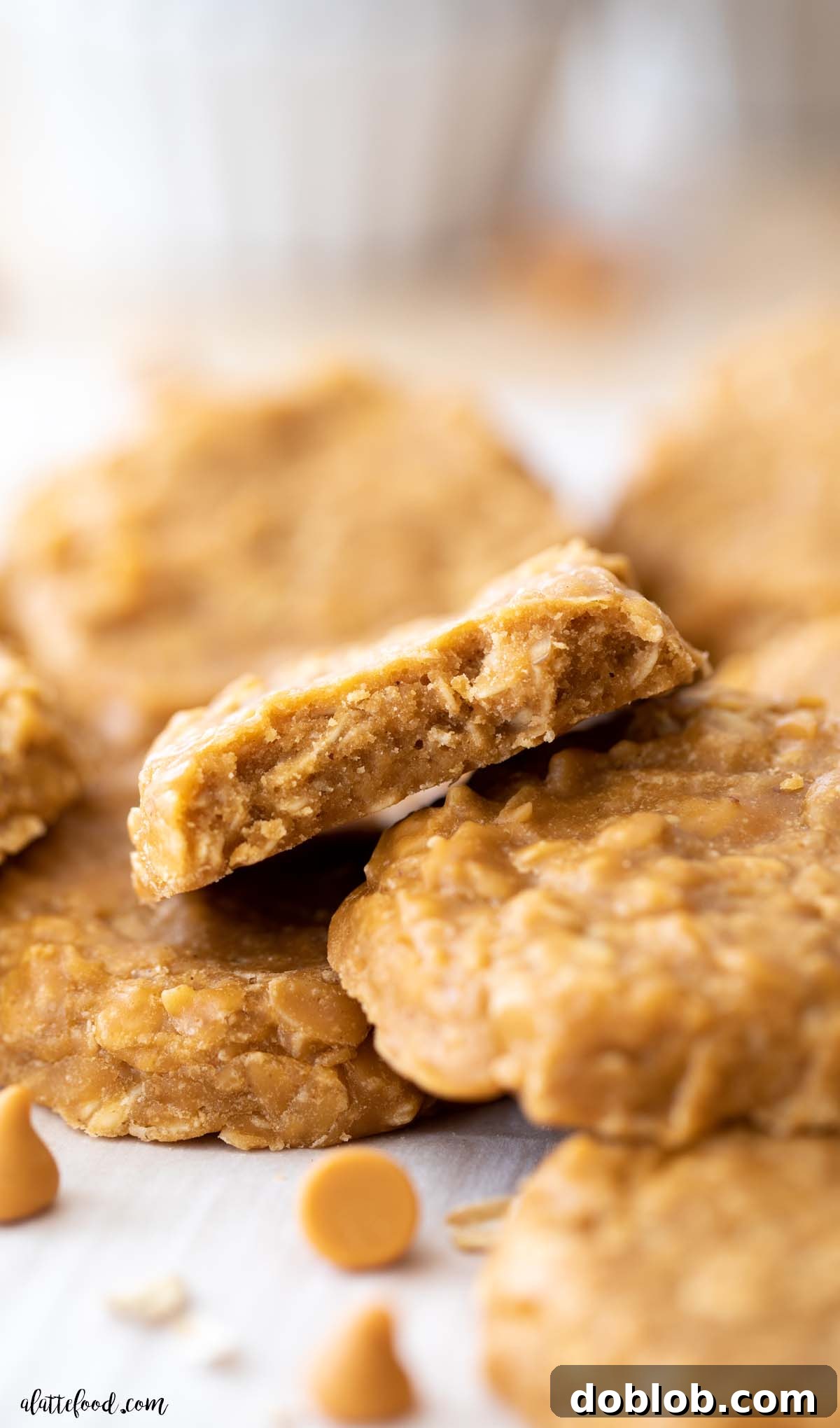 oatmeal butterscotch no bake cookies cut in half and stacked on white parchment paper