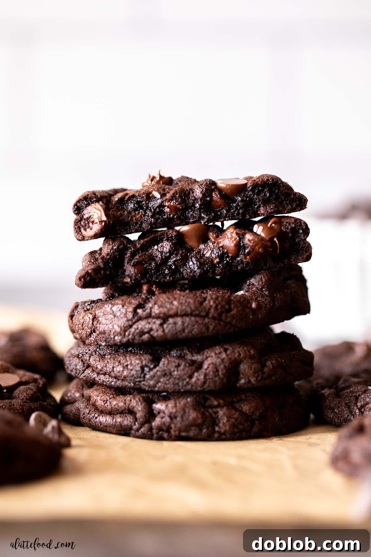 stack of double chocolate chip cookies with gooey chocolate chips melting inside. 