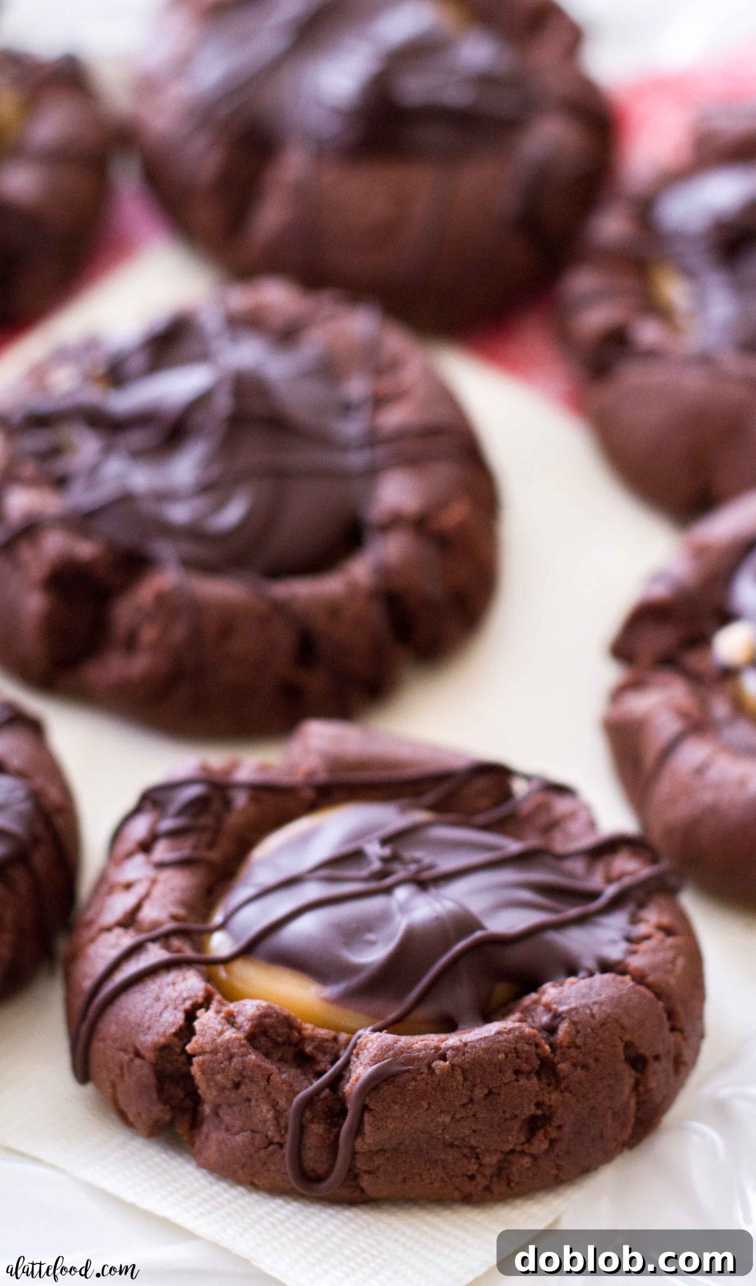 Rich Chocolate Caramel Thumbprint Cookies on a cooling rack, ready to be enjoyed as a holiday dessert.