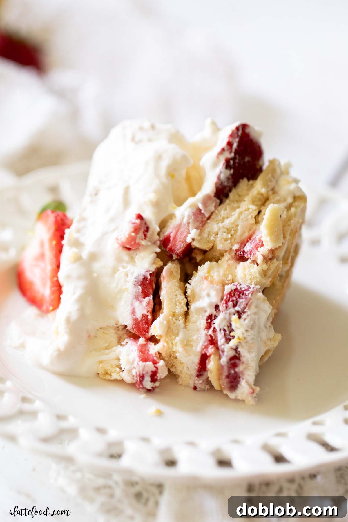 slice of strawberry lemon icebox cake on a white plate.
