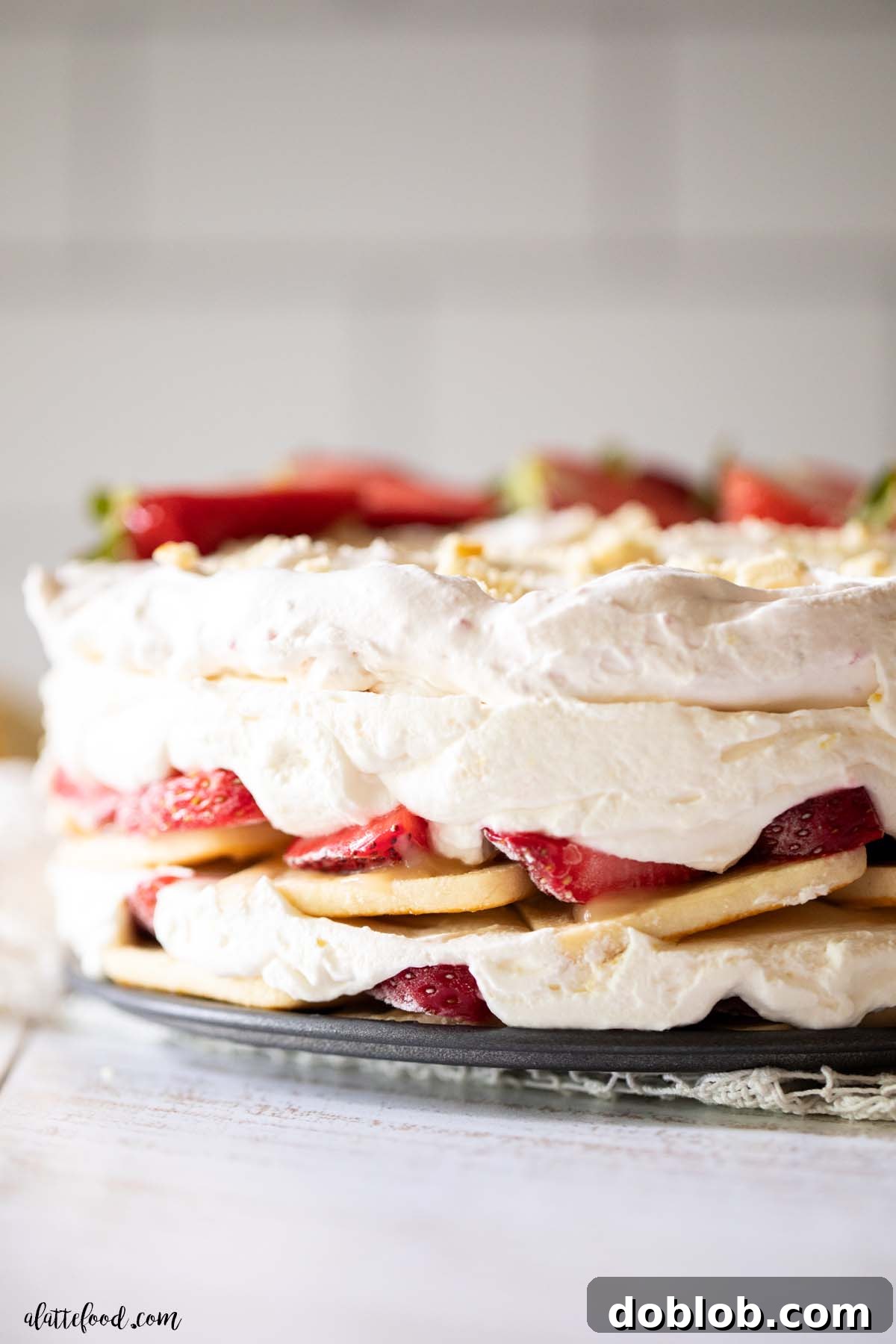 strawberry lemon icebox cake with shortbread cookies layered in a springform pan.