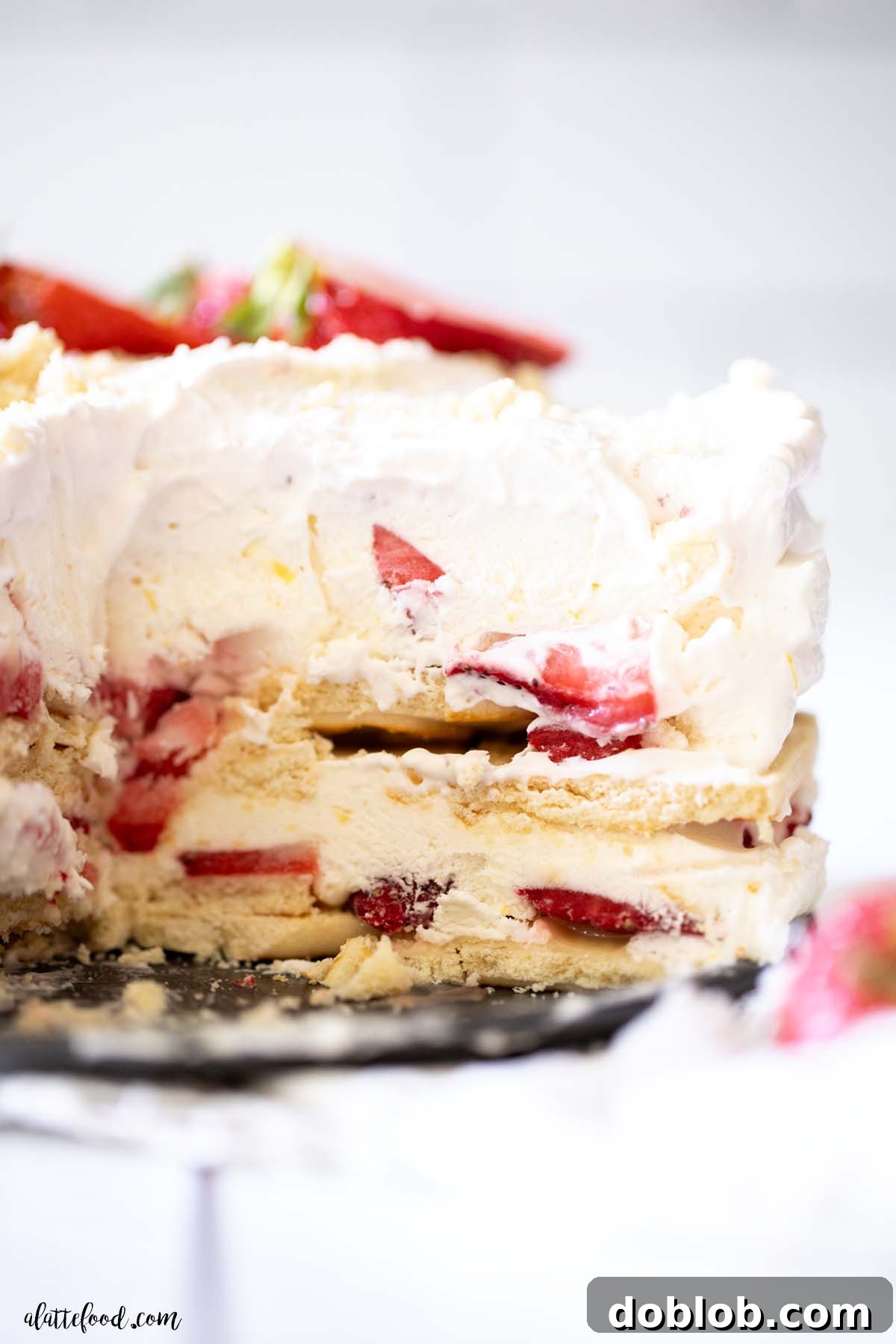 Strawberry Lemonade Icebox Cake 2 whipped cream strawberry lemon icebox cake on a cake stand.