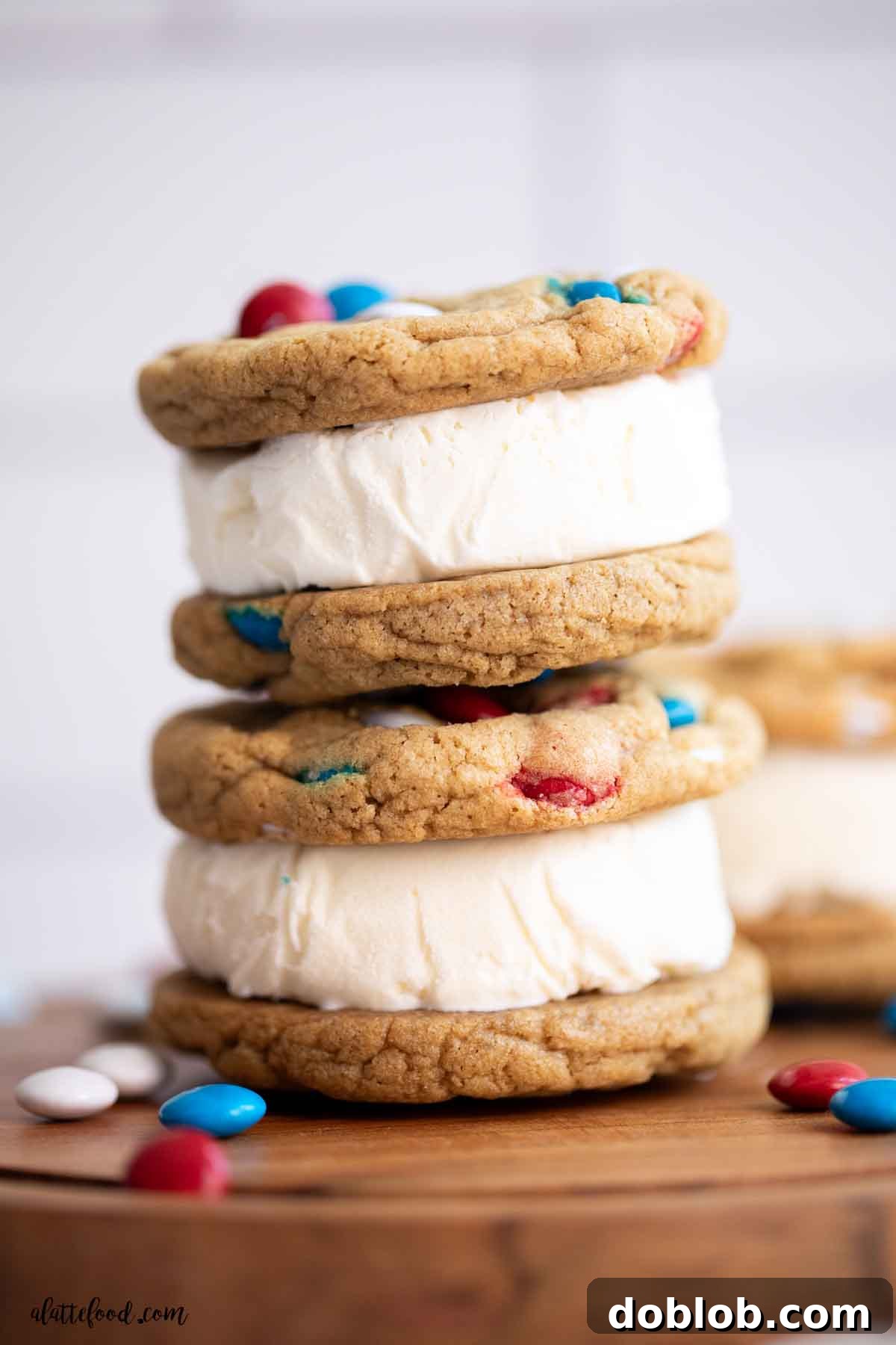 A delectable stack of homemade M&M cookie ice cream sandwiches, filled with creamy vanilla ice cream, promising a perfect summer treat.