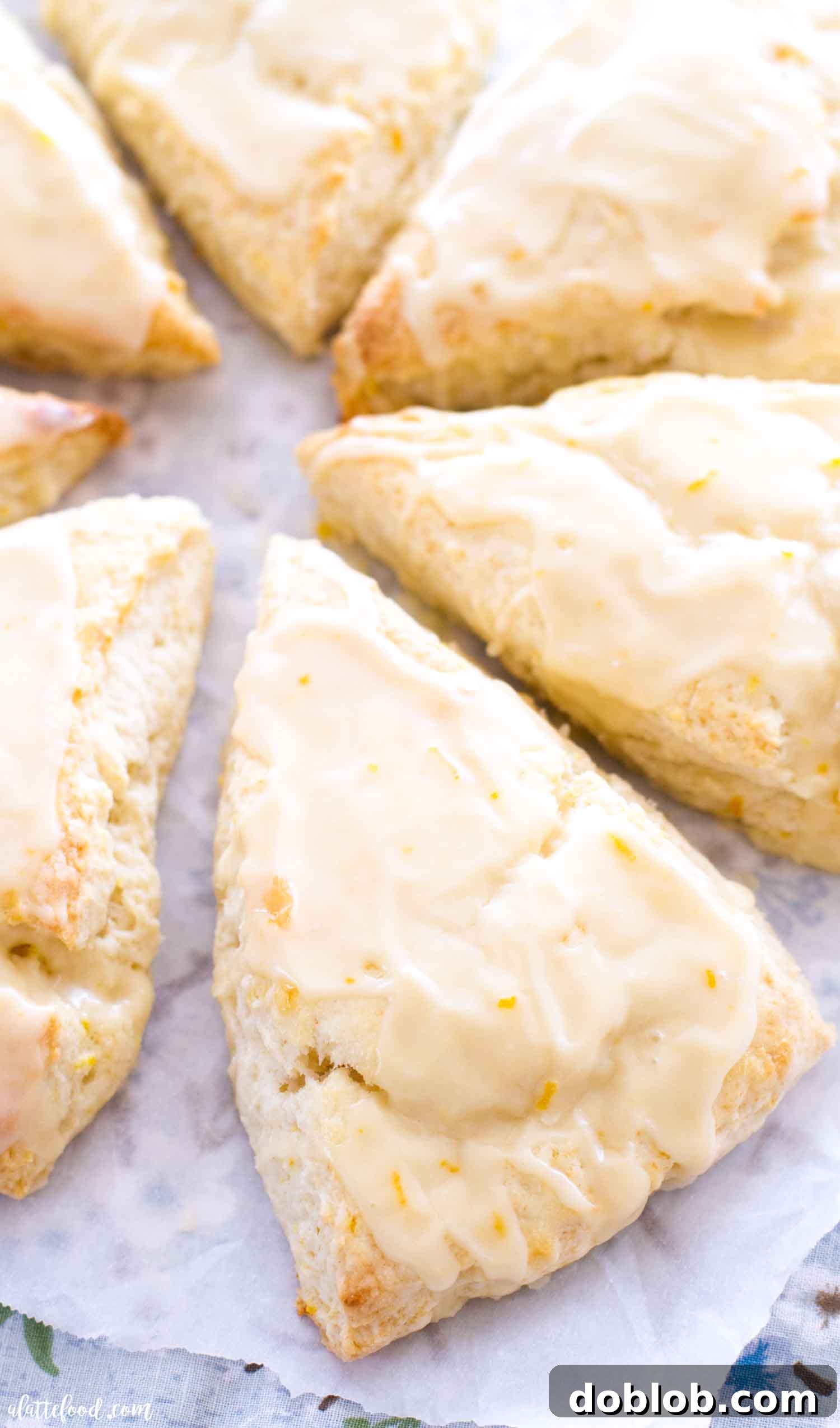 Dreamsicle Orange Cream Scones 6 Freshly baked orange glazed scones cooling on wax paper, ready to be enjoyed