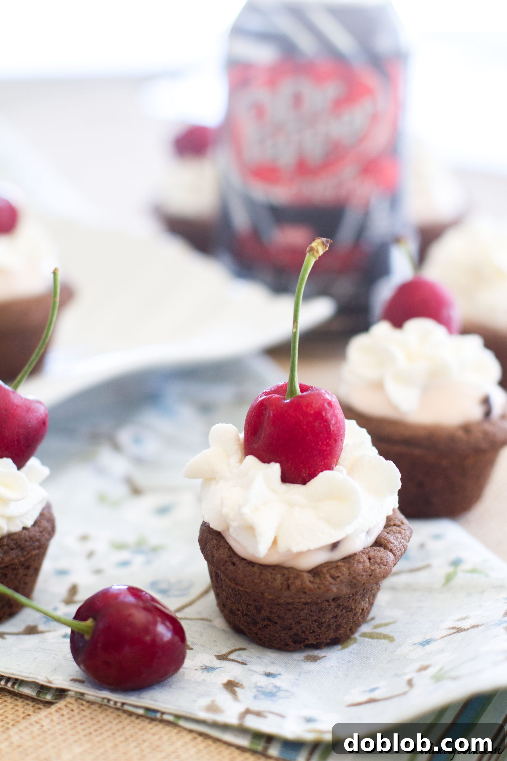 Close-up of Dr. Pepper Cherry cheesecake cookie cups with a fork