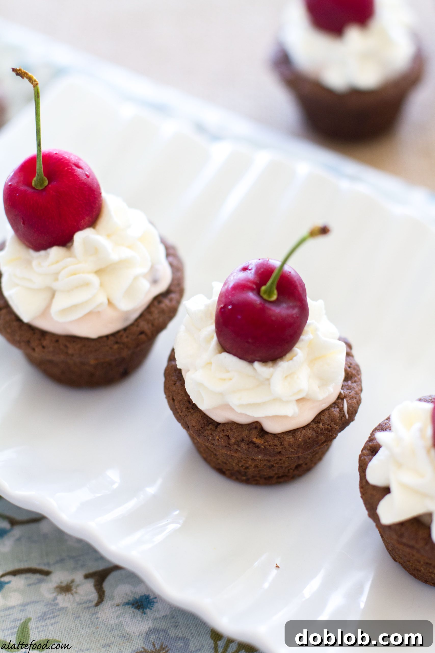 A close-up shot of Dr. Pepper Cherry cheesecake cookie cup with whipped cream and a cherry