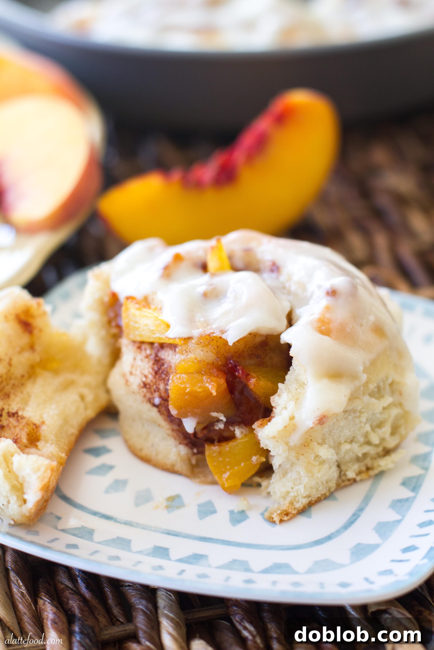 Close-up of gooey peach cinnamon rolls, freshly baked and ready for glazing.