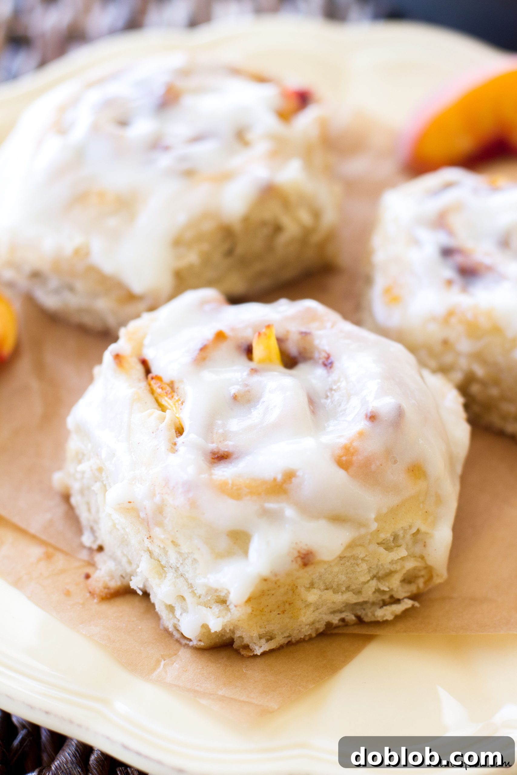 A tray of unglazed peach cinnamon rolls, golden brown and perfectly baked.