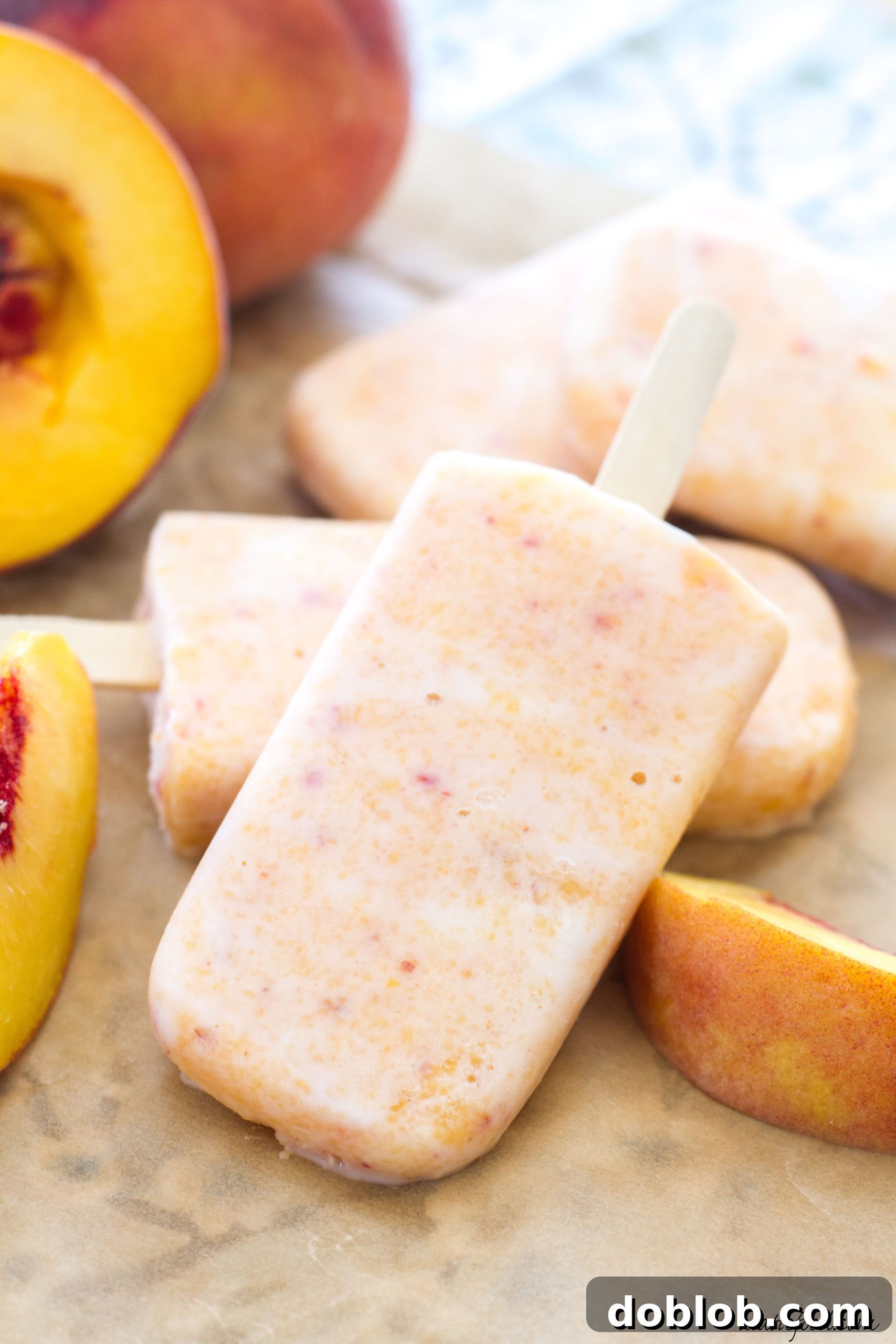 Delicious and healthy creamy peach popsicles made with Greek yogurt and honey for a refreshing summer treat