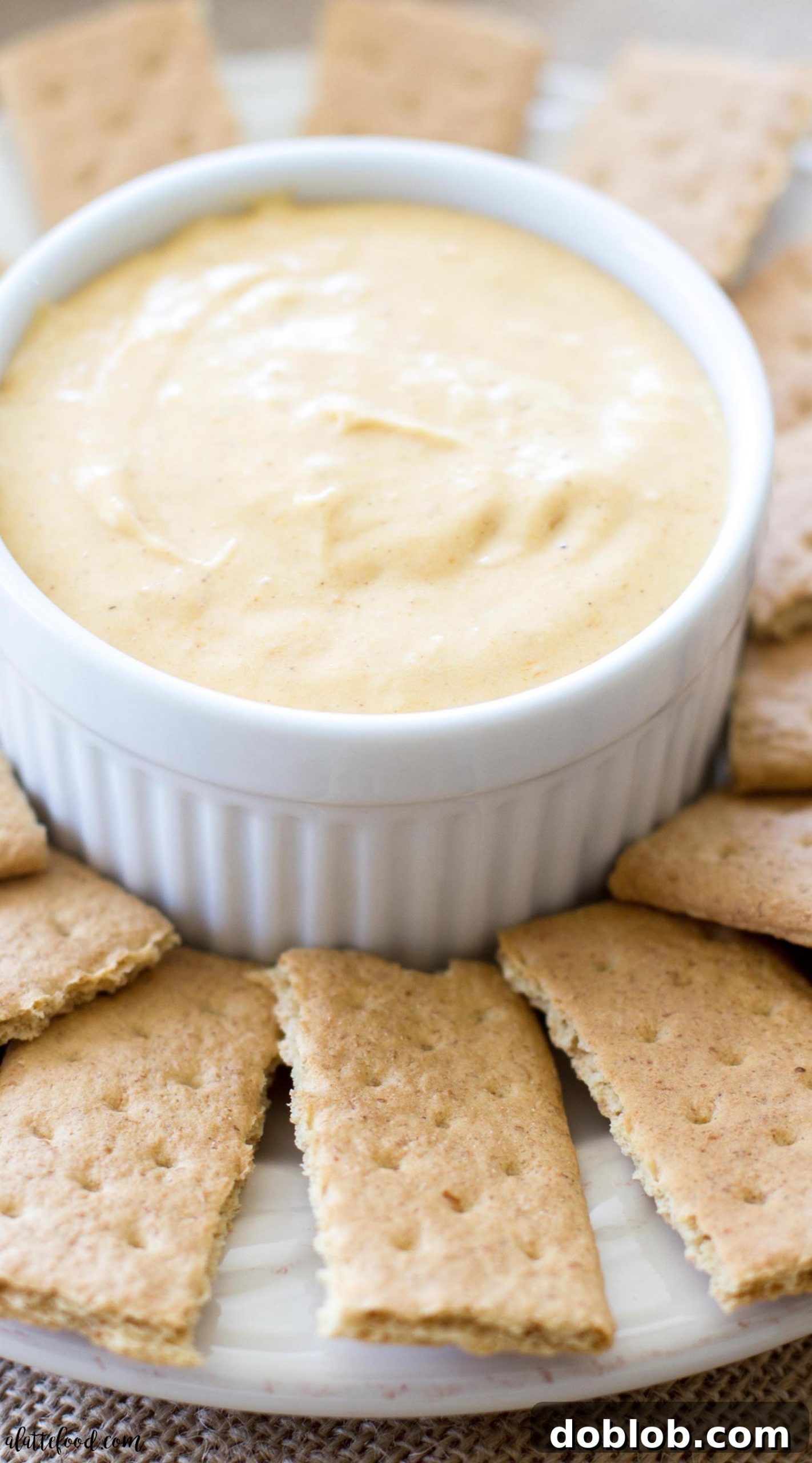 Dreamy Pumpkin Cloud Dip 5 A large serving of creamy pumpkin pie fluff dip in a rustic white dish