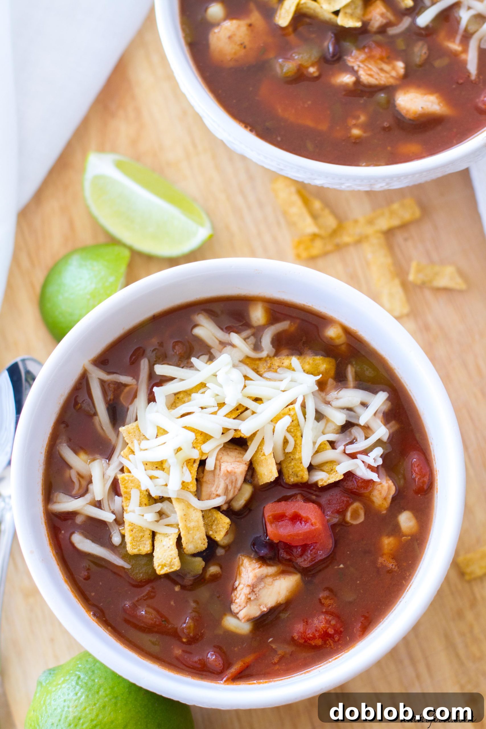 30-Minute Chicken Tortilla Soup 5 A generous serving of chicken tortilla soup in a white bowl, ready to be topped.