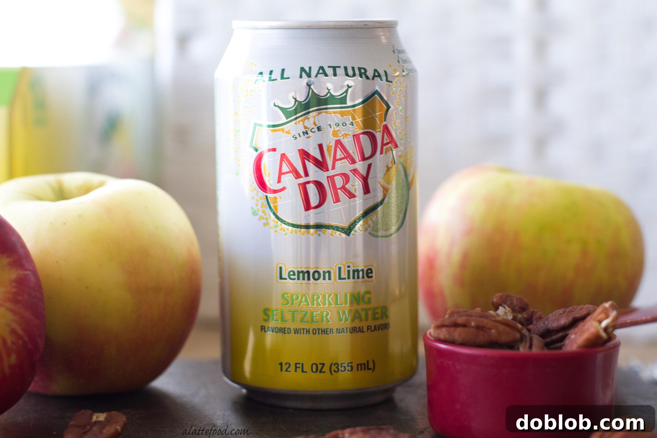 A vibrant overhead shot of pecan pie pancakes with apples, cinnamon, and syrup ready to be served.