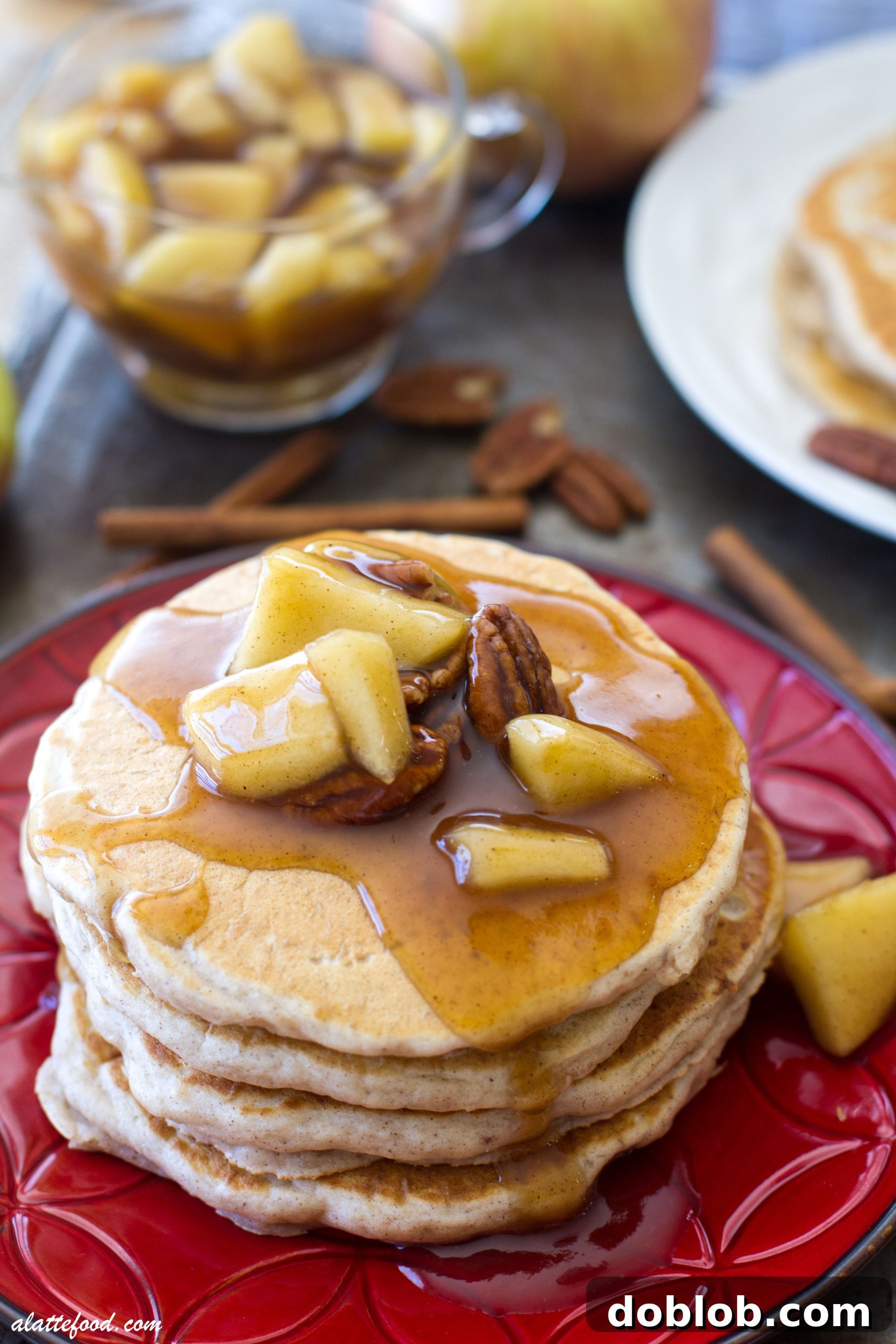 A pancake being cooked on a griddle, showing the bubbling batter as it cooks.
