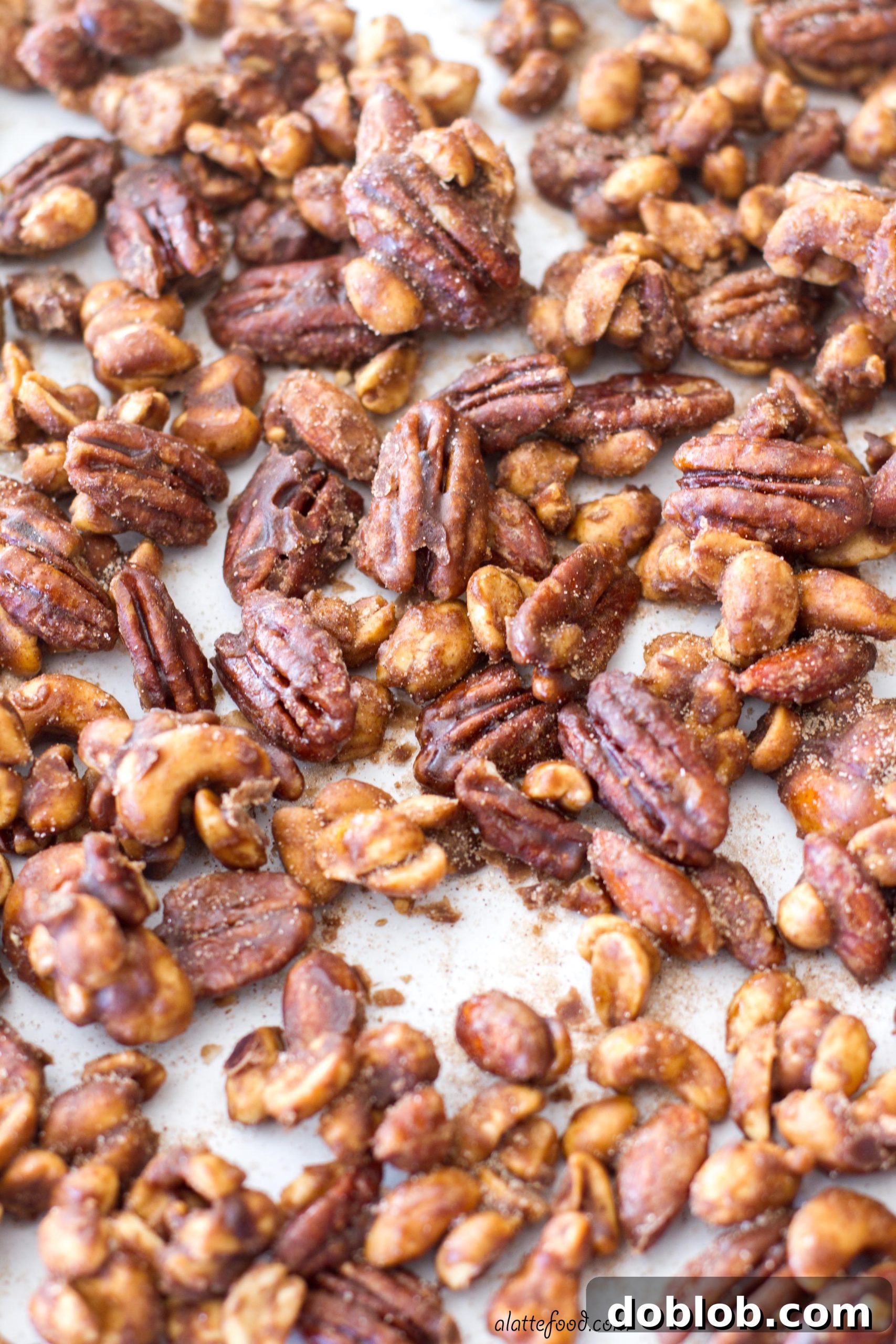Close-up of golden brown apple spice candied pecans, almonds, and cashews