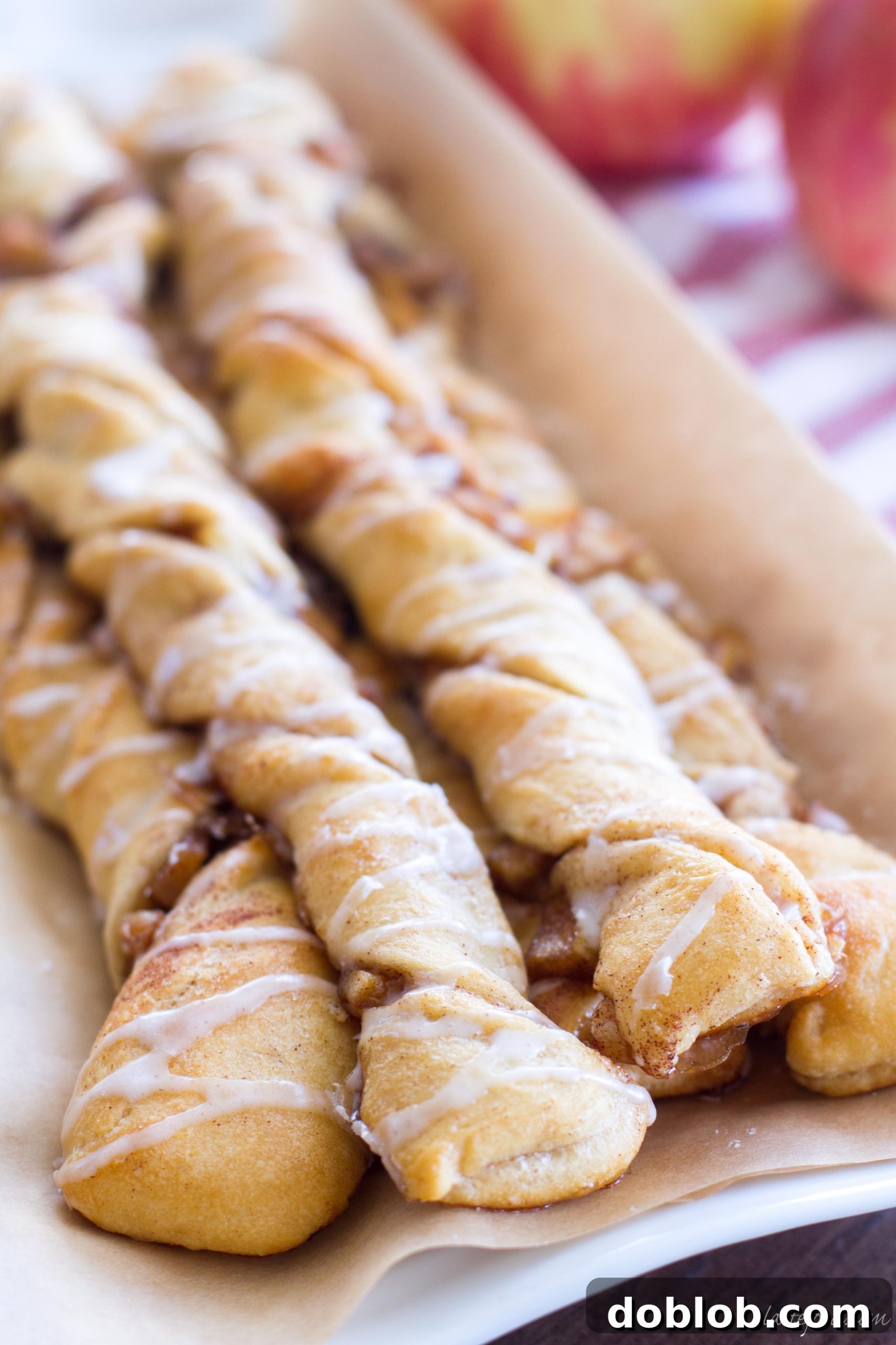 Close-up shot of a plate of freshly baked apple danish twists, inviting and delicious